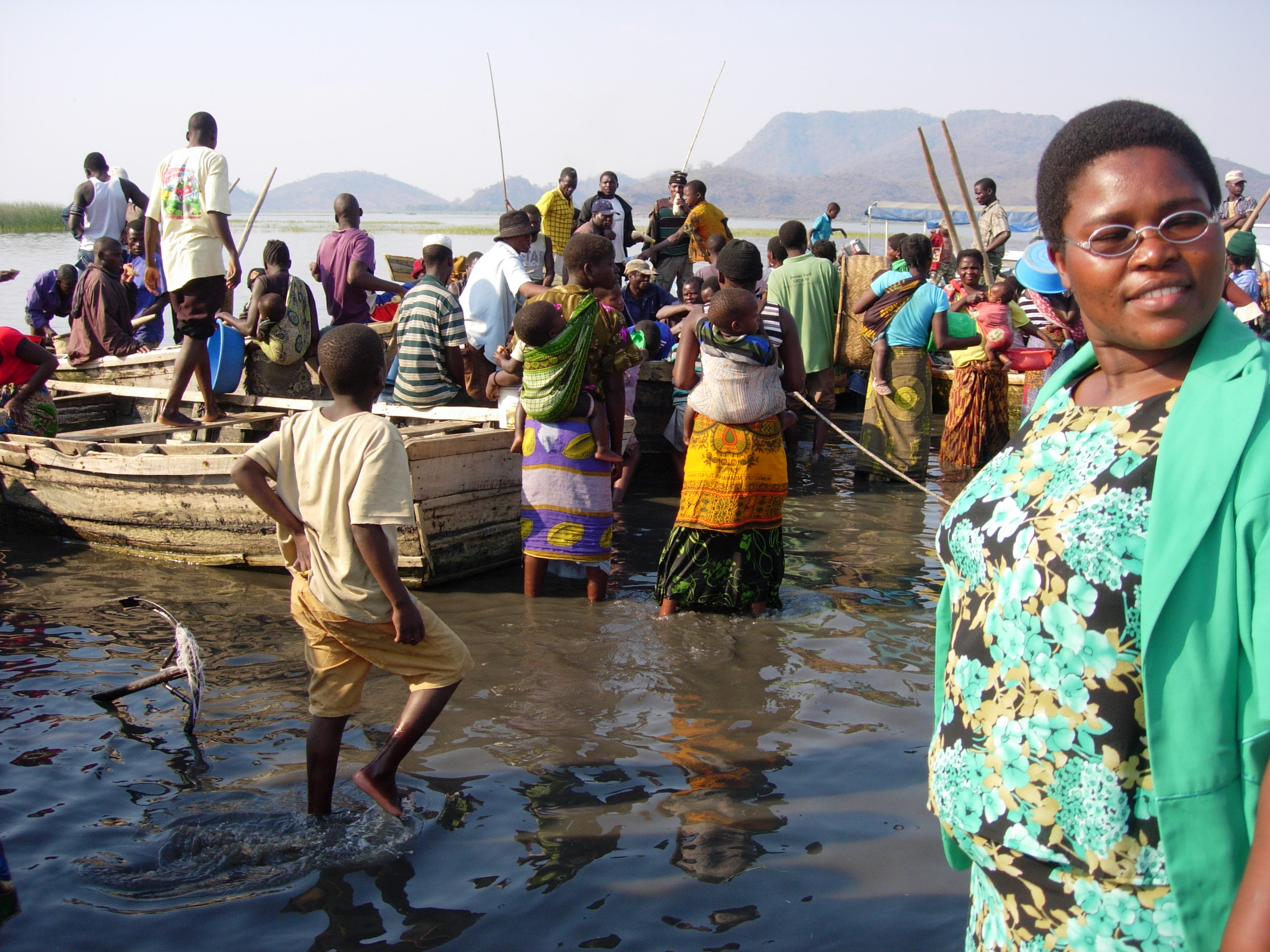 people milling around a fishing boat