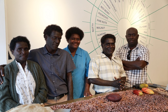a group of people with cocoa products
