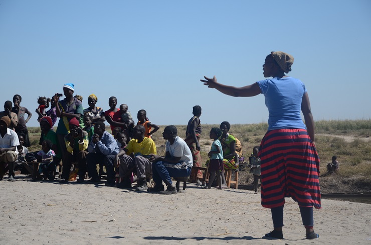 woman with arm outstretched to group of people