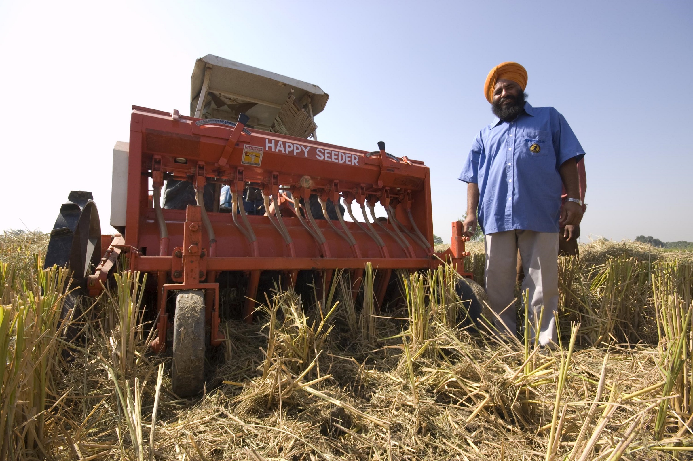 a man beside a seeder