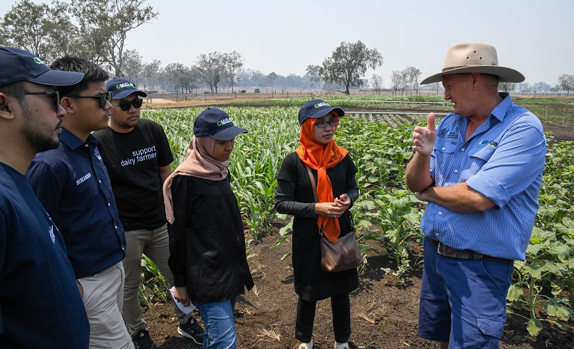 a man talking to group of farmers