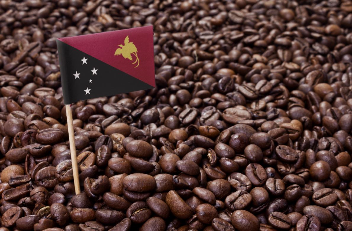 Papua New Guinea flag in a bed of coffee beans