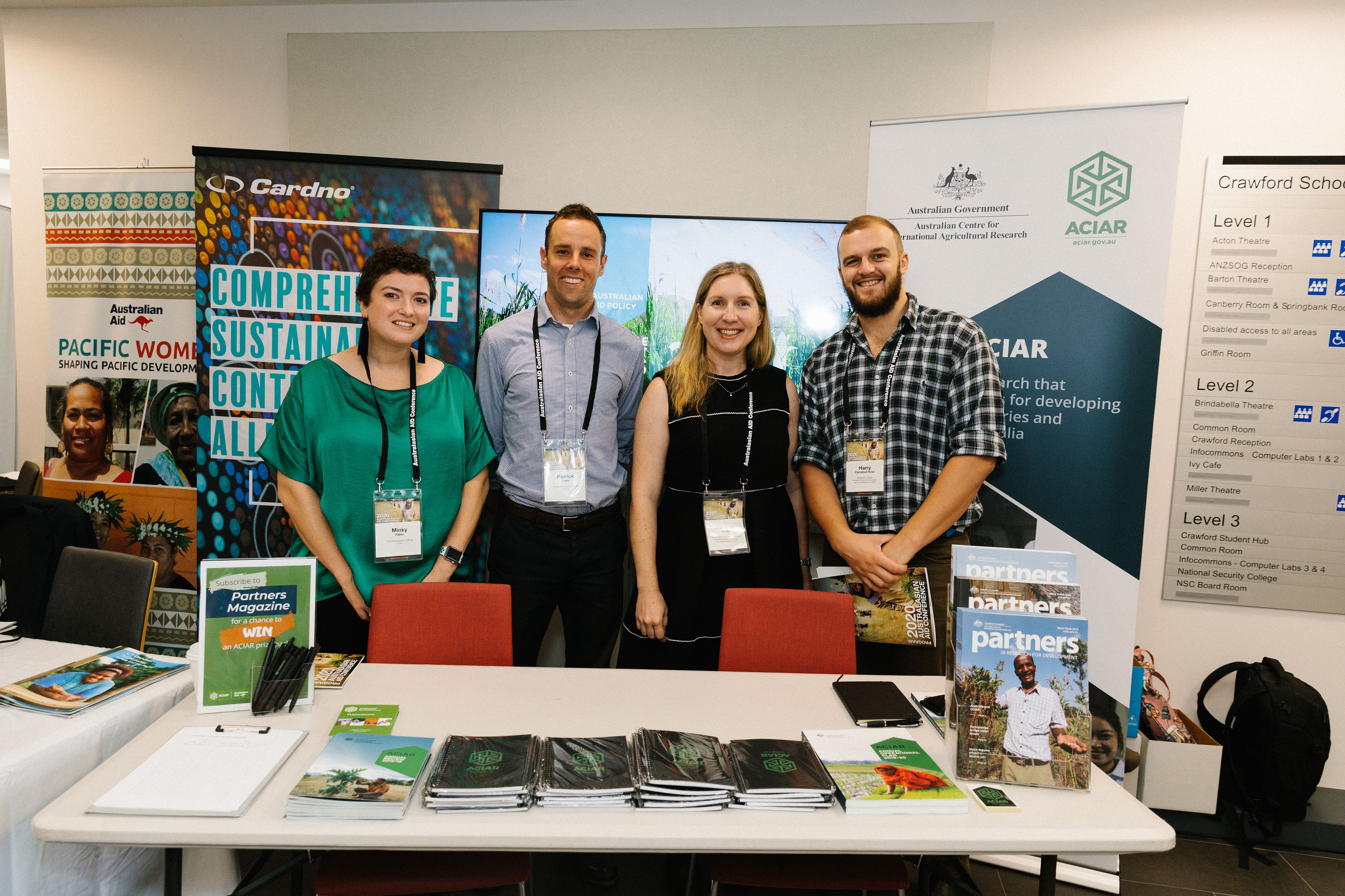 Four ACIAR staff members at a promotional booth