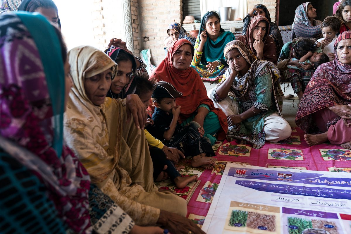 Group of women in saris in an outdoor meeting