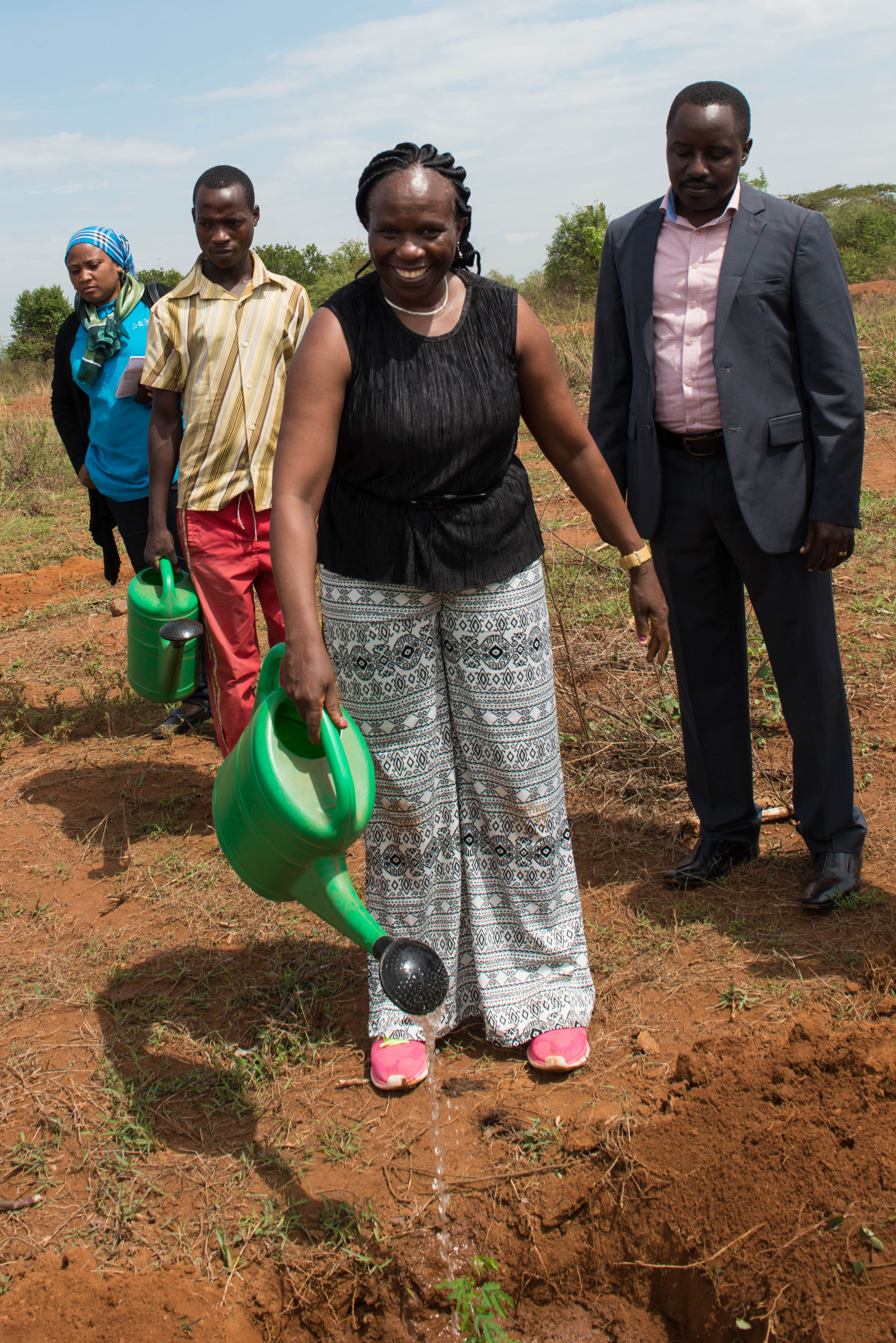 Catherine Muthuri, ICRAF Regional Coordinator for Eastern and Southern Africa Region and Trees for Food Security Project Manager, watering a tree during a field visit.