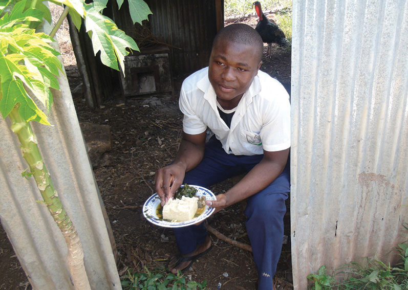 Man in a shed with a plate of food