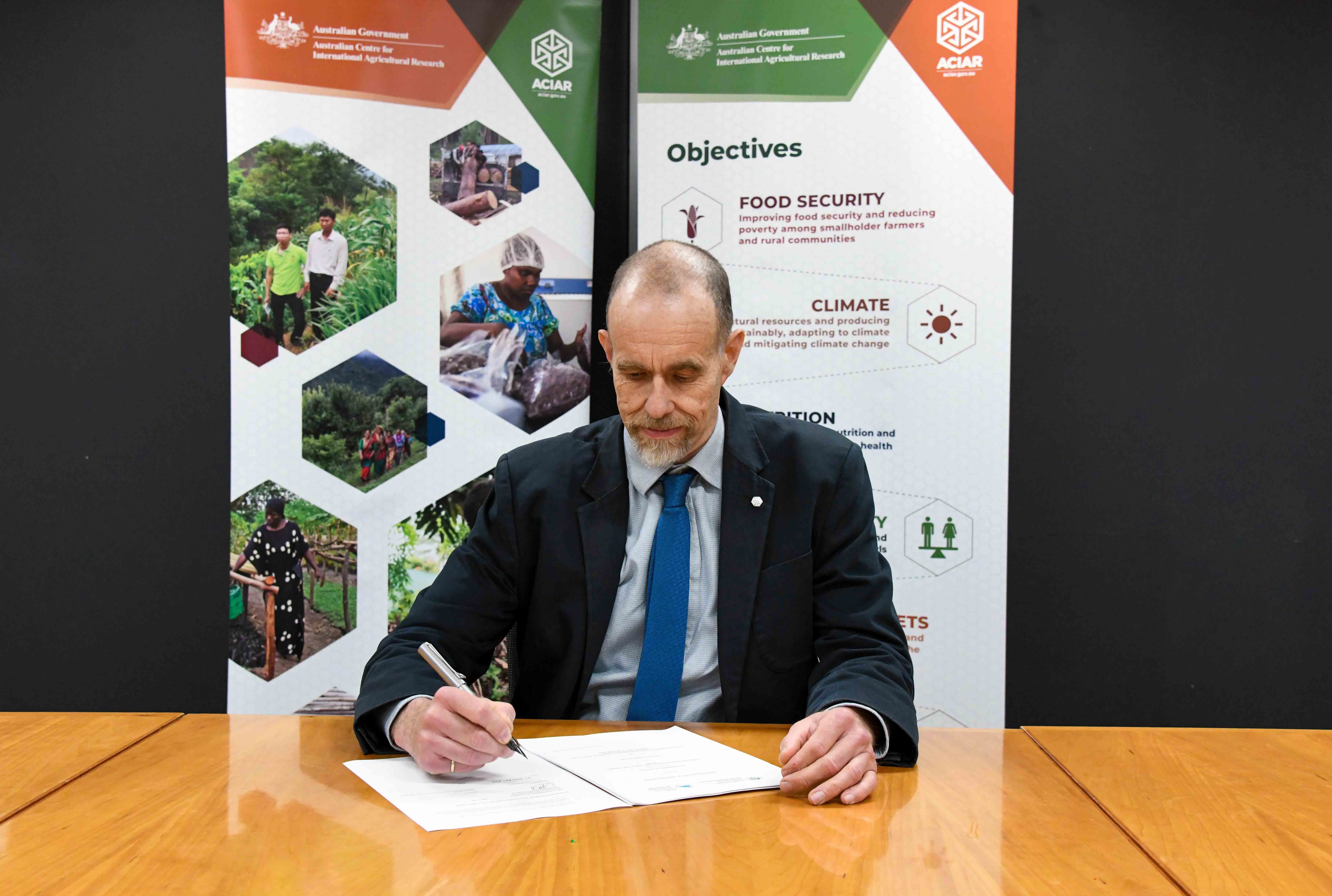 Dr Daniel Walker signing the new partnership agreement with SPC at ACIAR House in Canberra. 