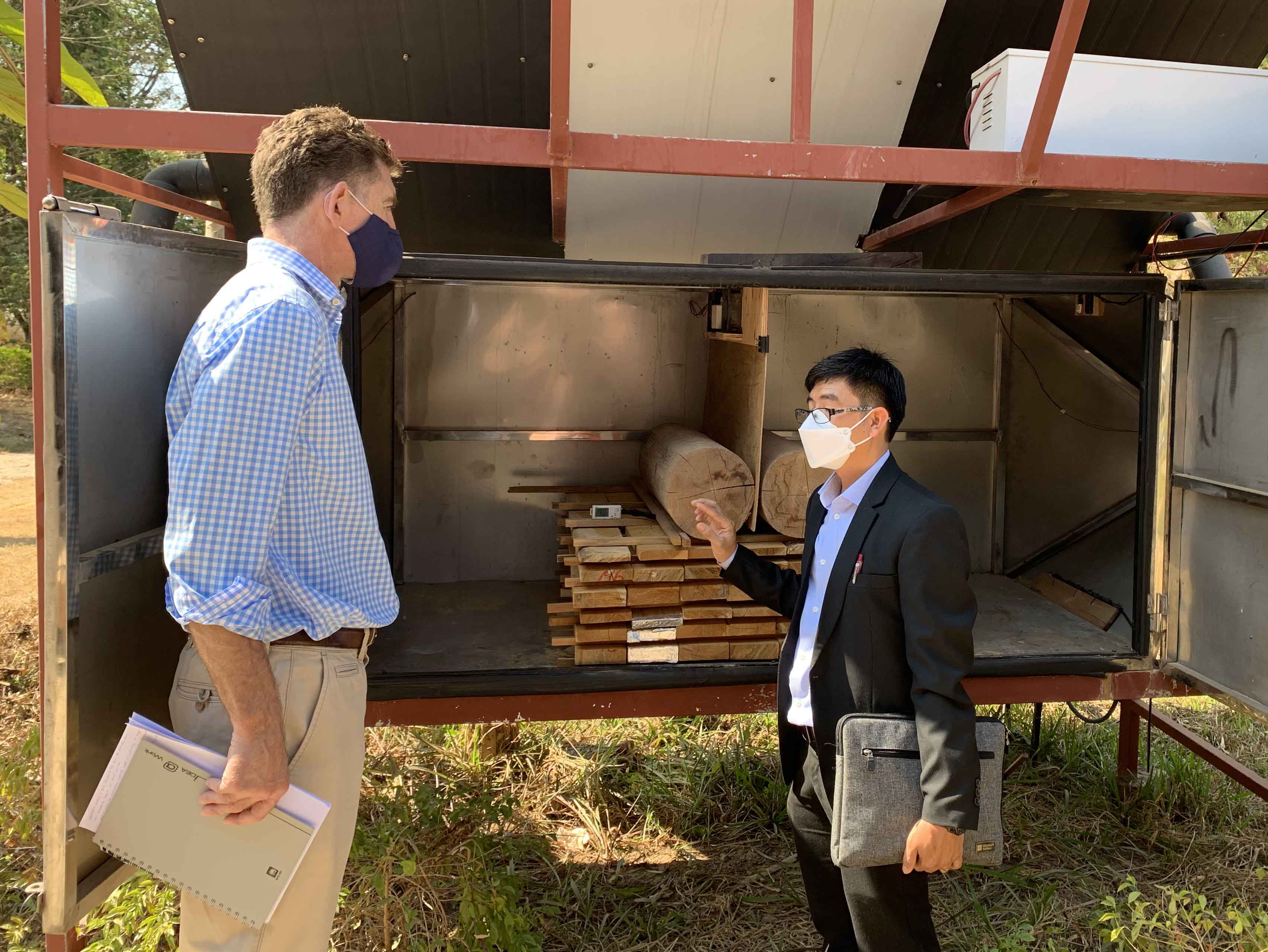 Deputy Head of Mission at the Australian Embassy in Lao PDR, Dan Heldon (left) with ACIAR Alumni, Dr Khamtan Phonetip (right) inspecting a solar kiln during a recent visit.