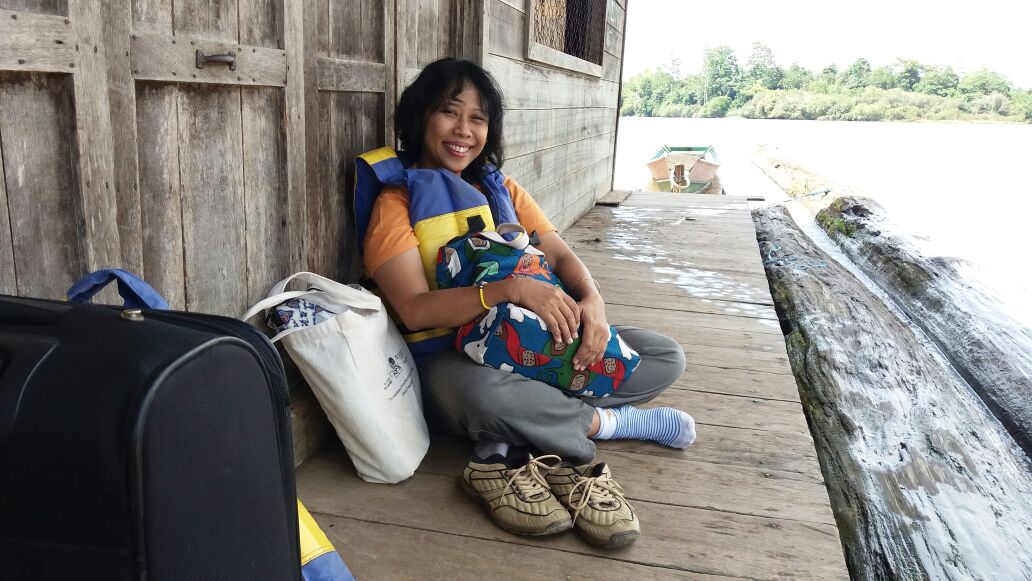 Woman sitting smiling on porch