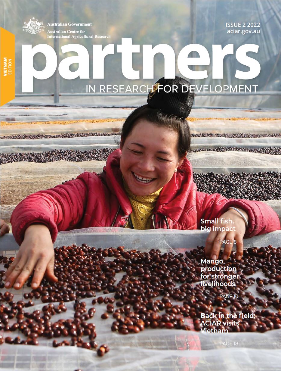 Partners magazine 2022 Issue 2 cover with woman harvesting coffee beans