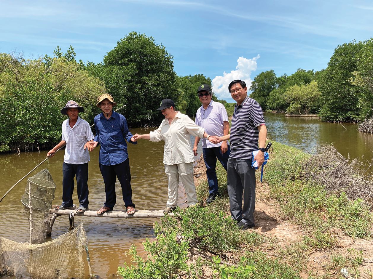 Group of men and women visiting a business owner