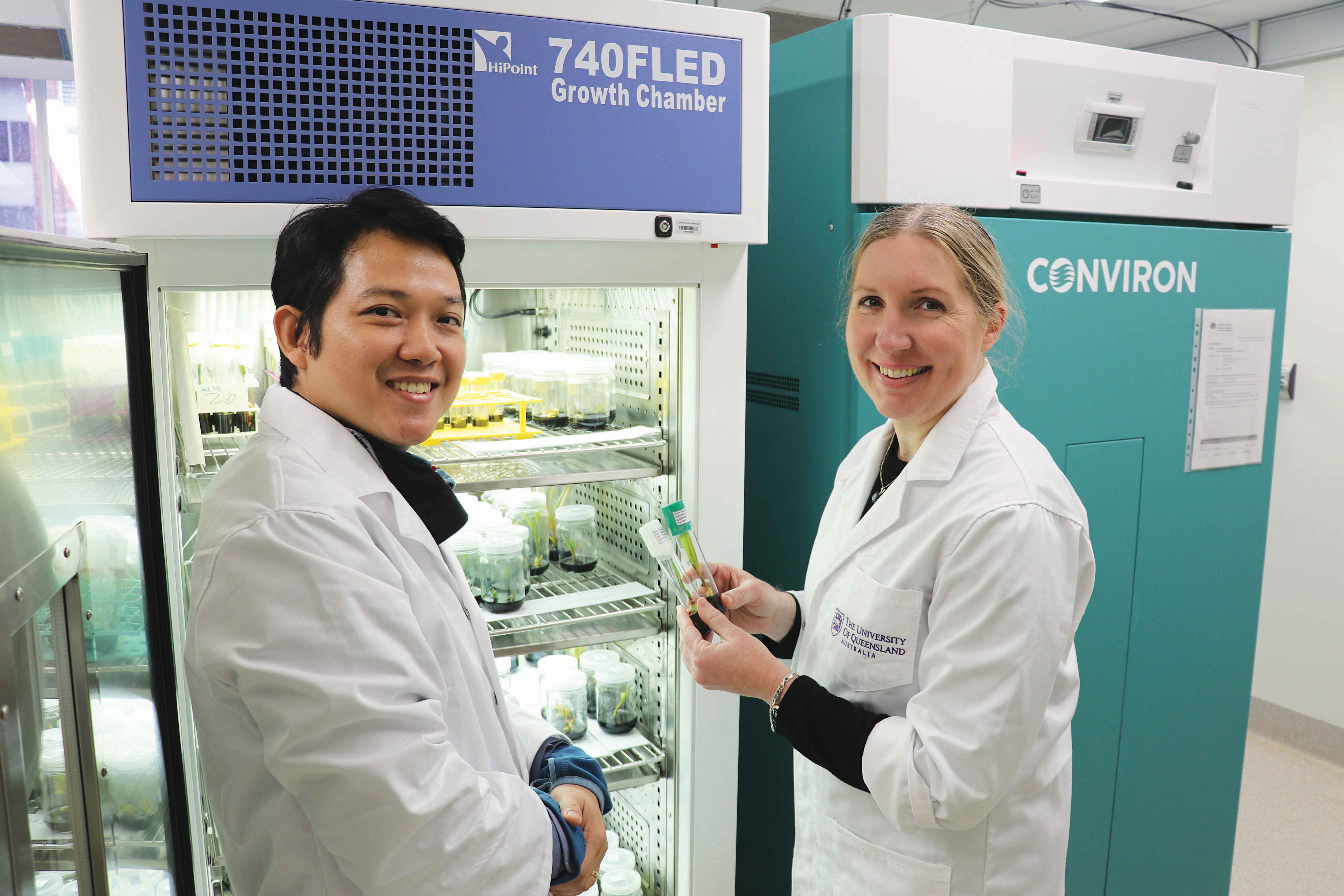 Dr Julianne Biddle (right) and Quang Nguyen inspect coconut varieties in front of a fridge