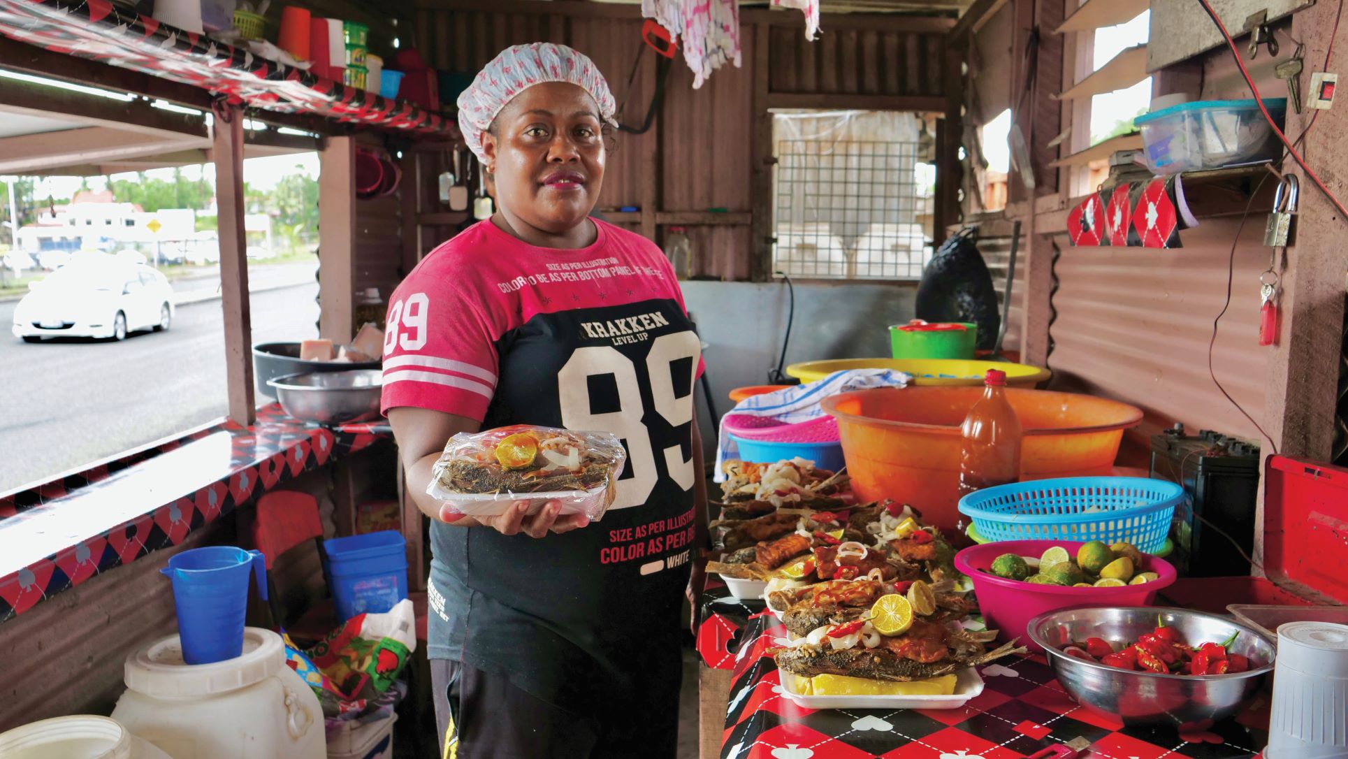 Woman in a kitchen holding food