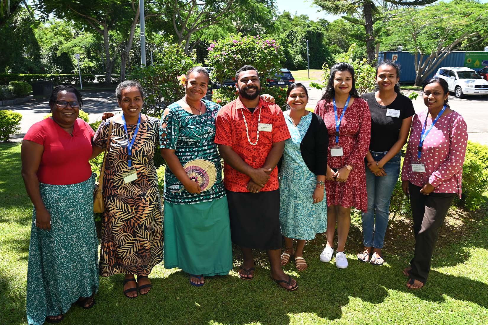 A group of 6 women and one man smiling at the camera.