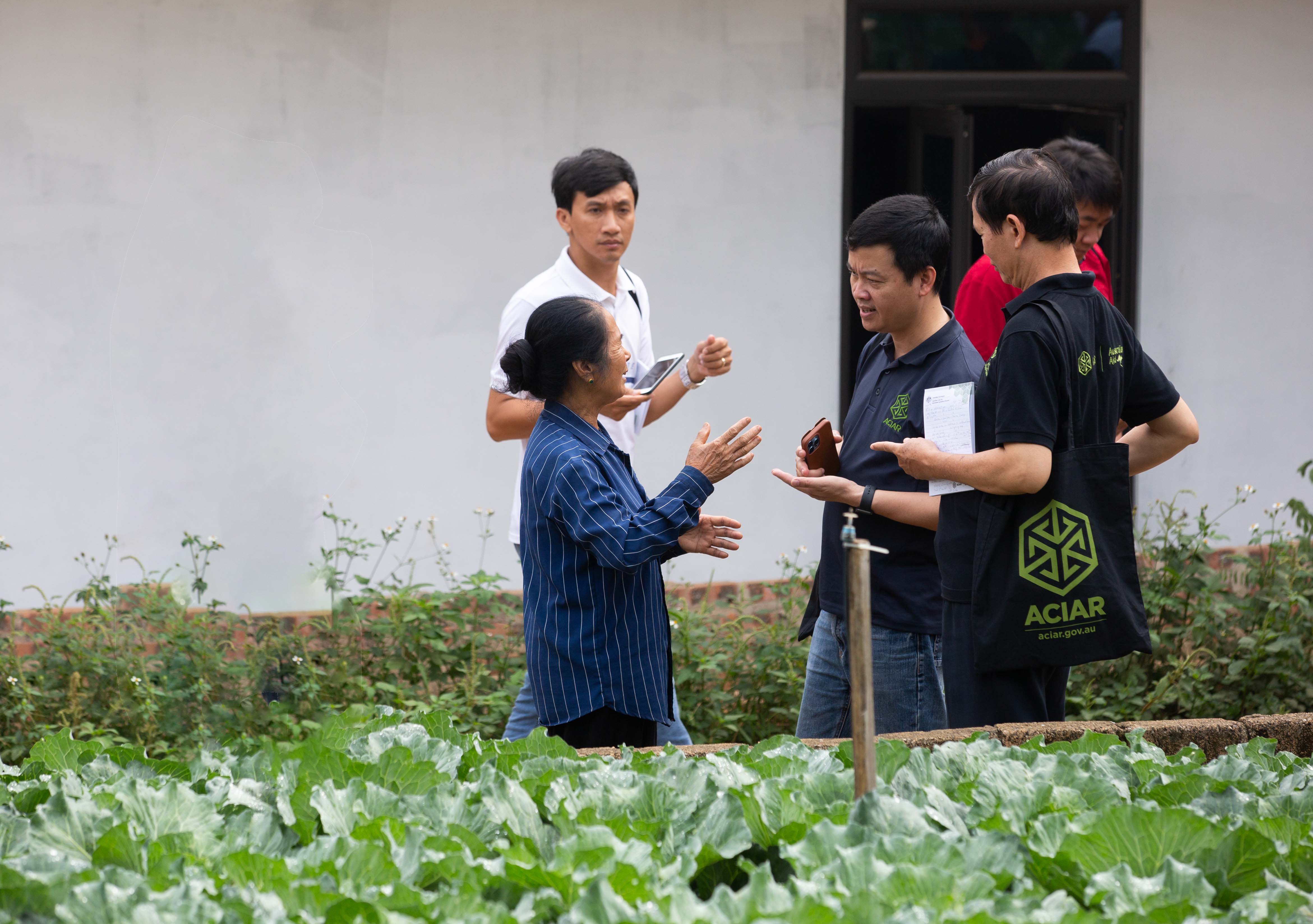 Alumni speaking with farmers in northwest Vietnam 