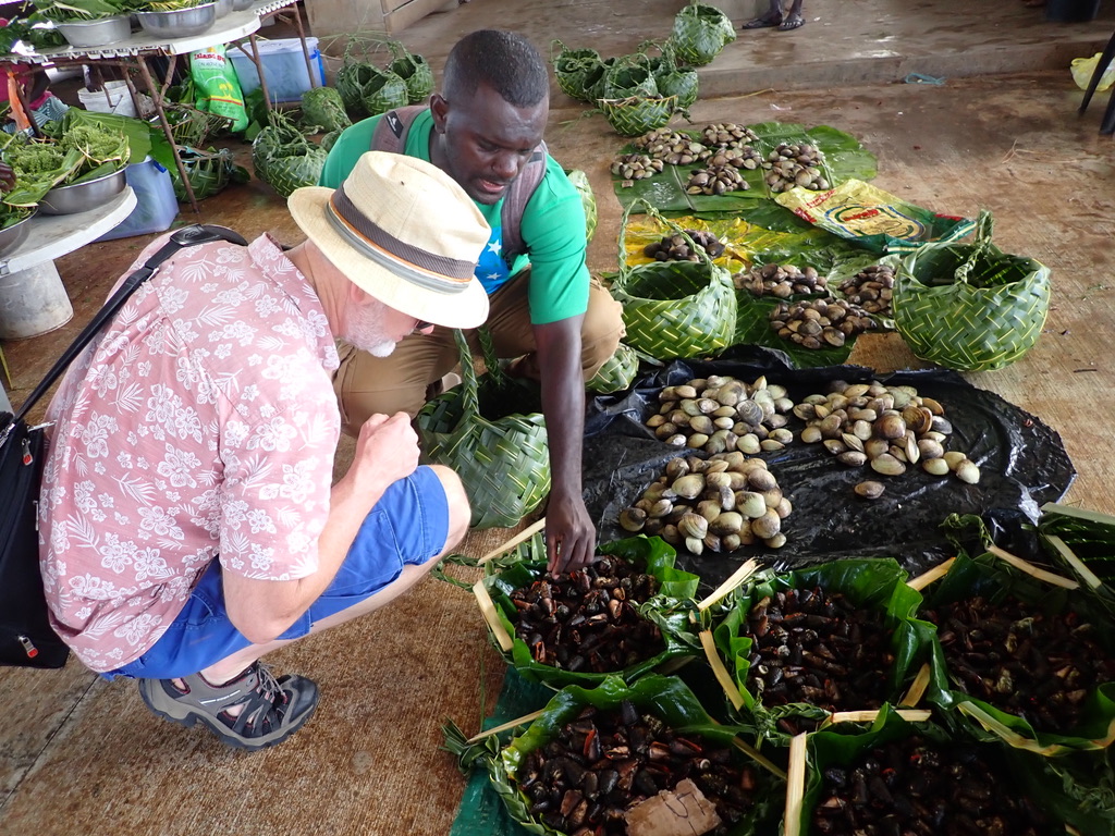 Project Leader Dr James Butler inspects produce at a local market in the Solomon Islands.