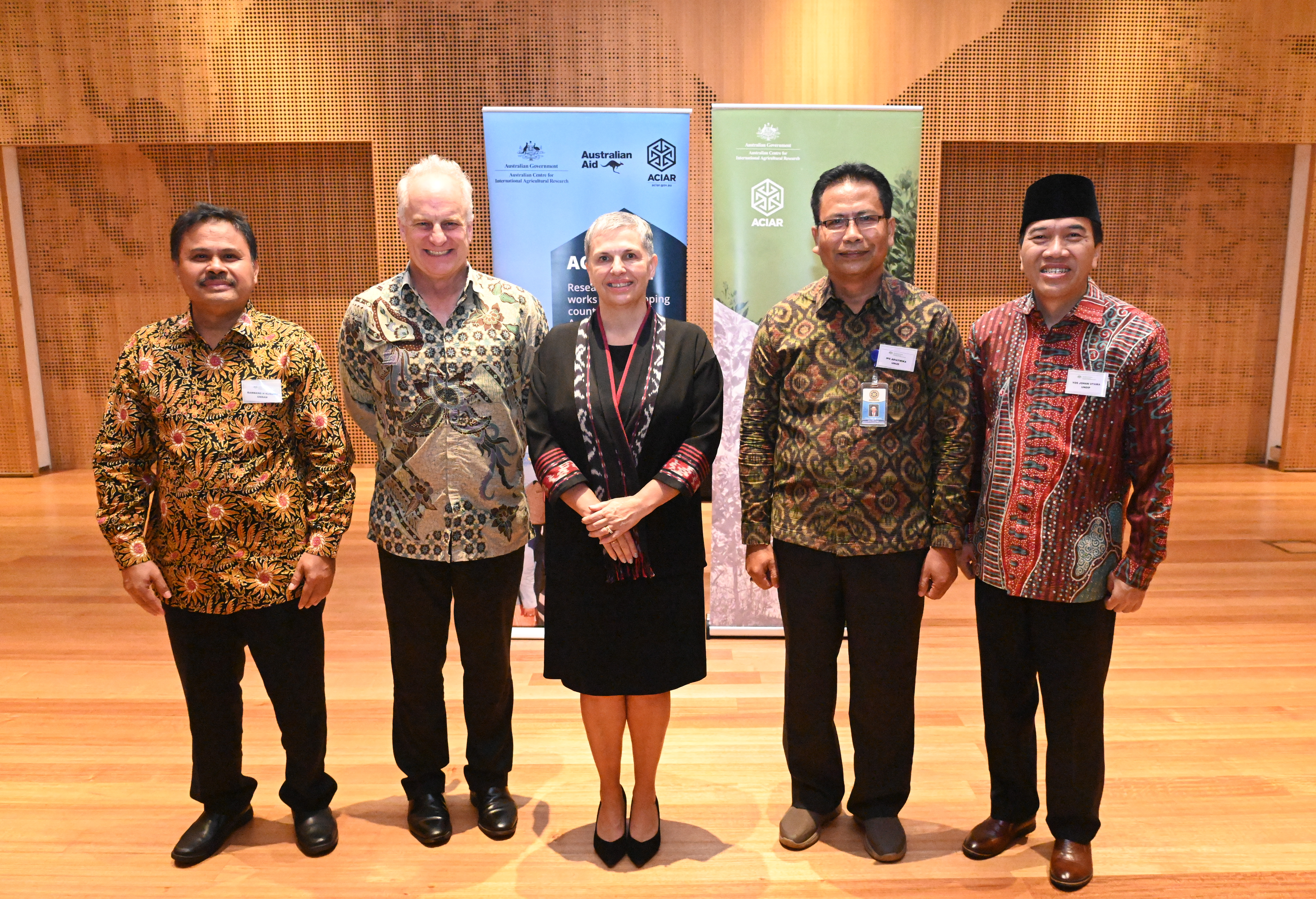 Group of 4 men and 1 woman smiling