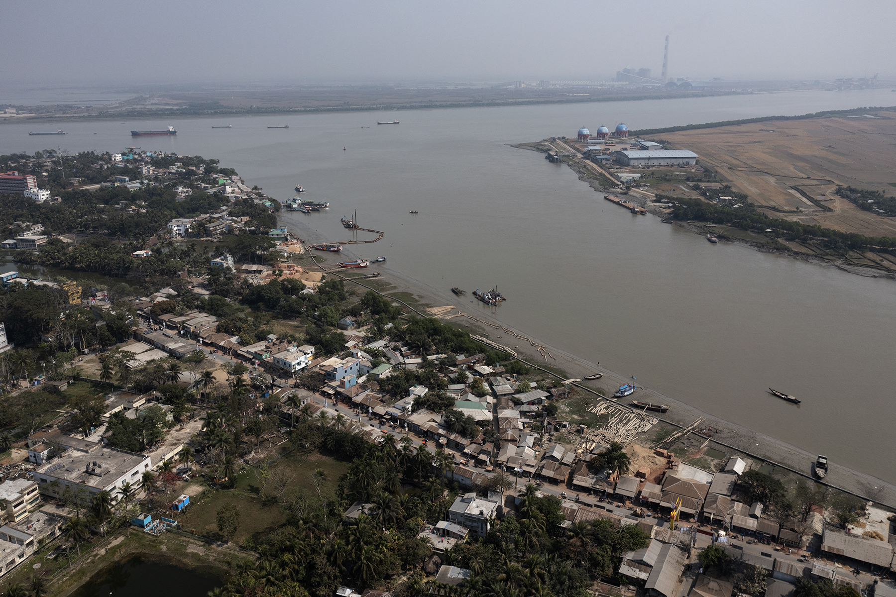 An aerial shot of a waterway in Bangladesh, bordered by houses
