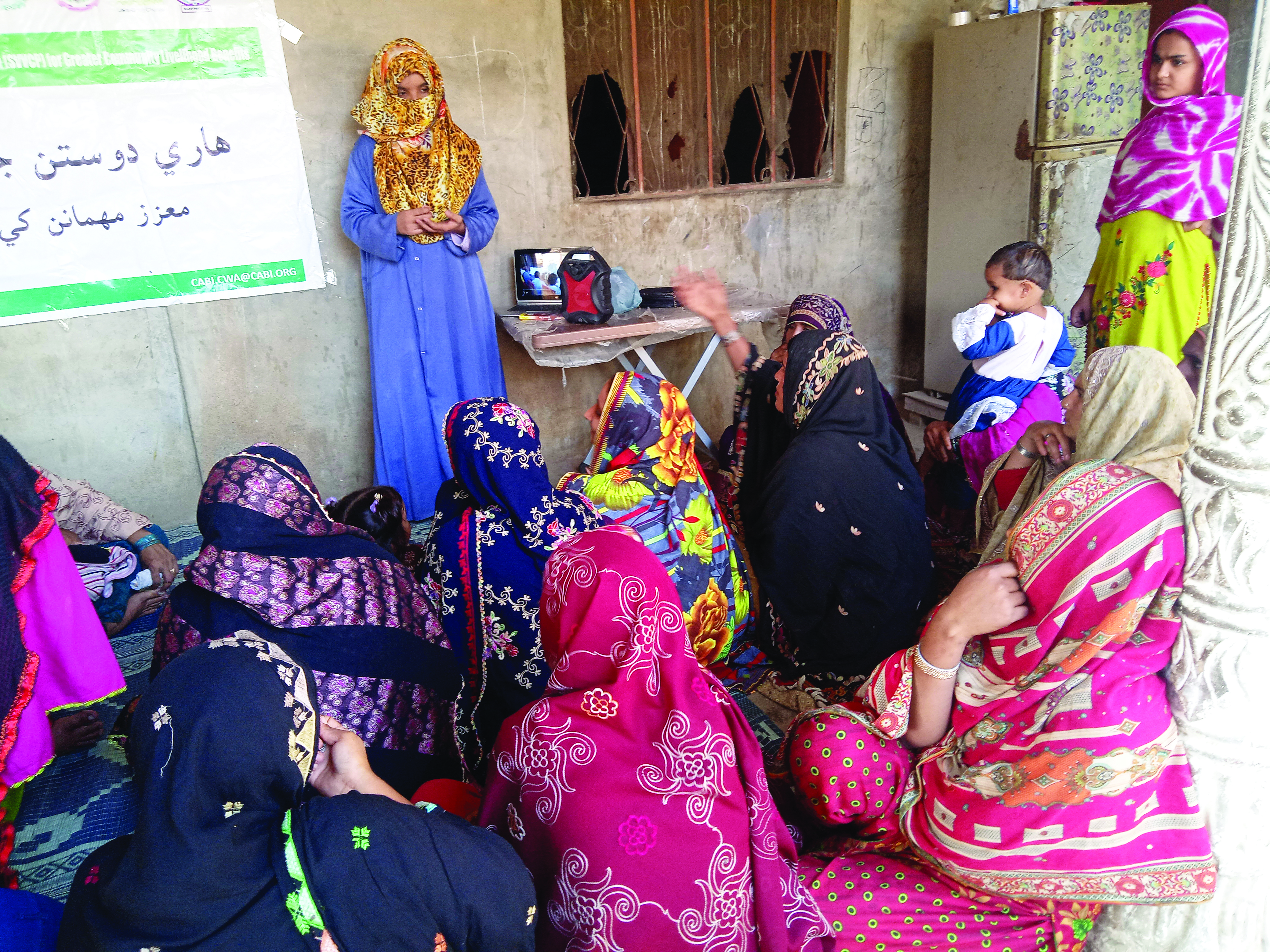 A group of women in an ouotdoor class wearing colourful clothing and scarfs