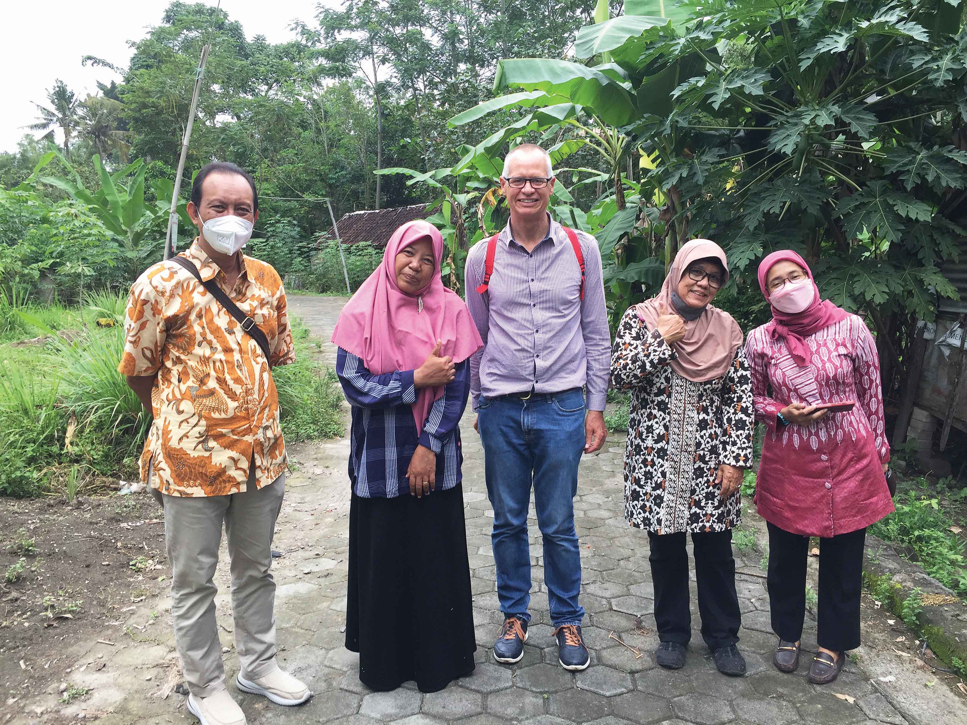 3 women and 2 men smiling outdoors