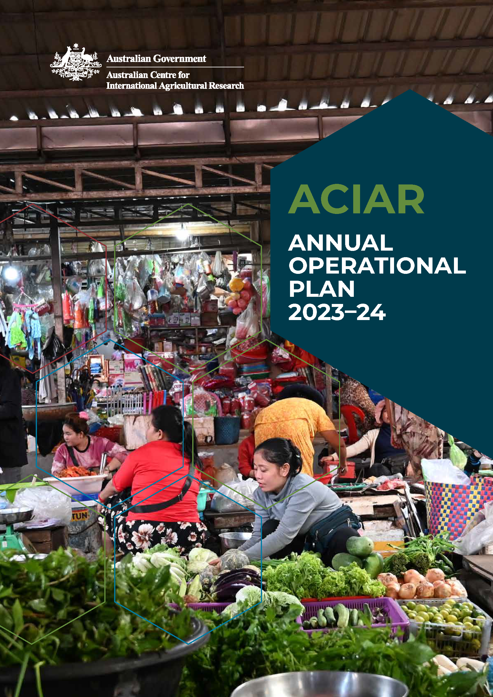 An undercover market place, with rows of vegetables in the foreground and people working at stalls in the mid view.