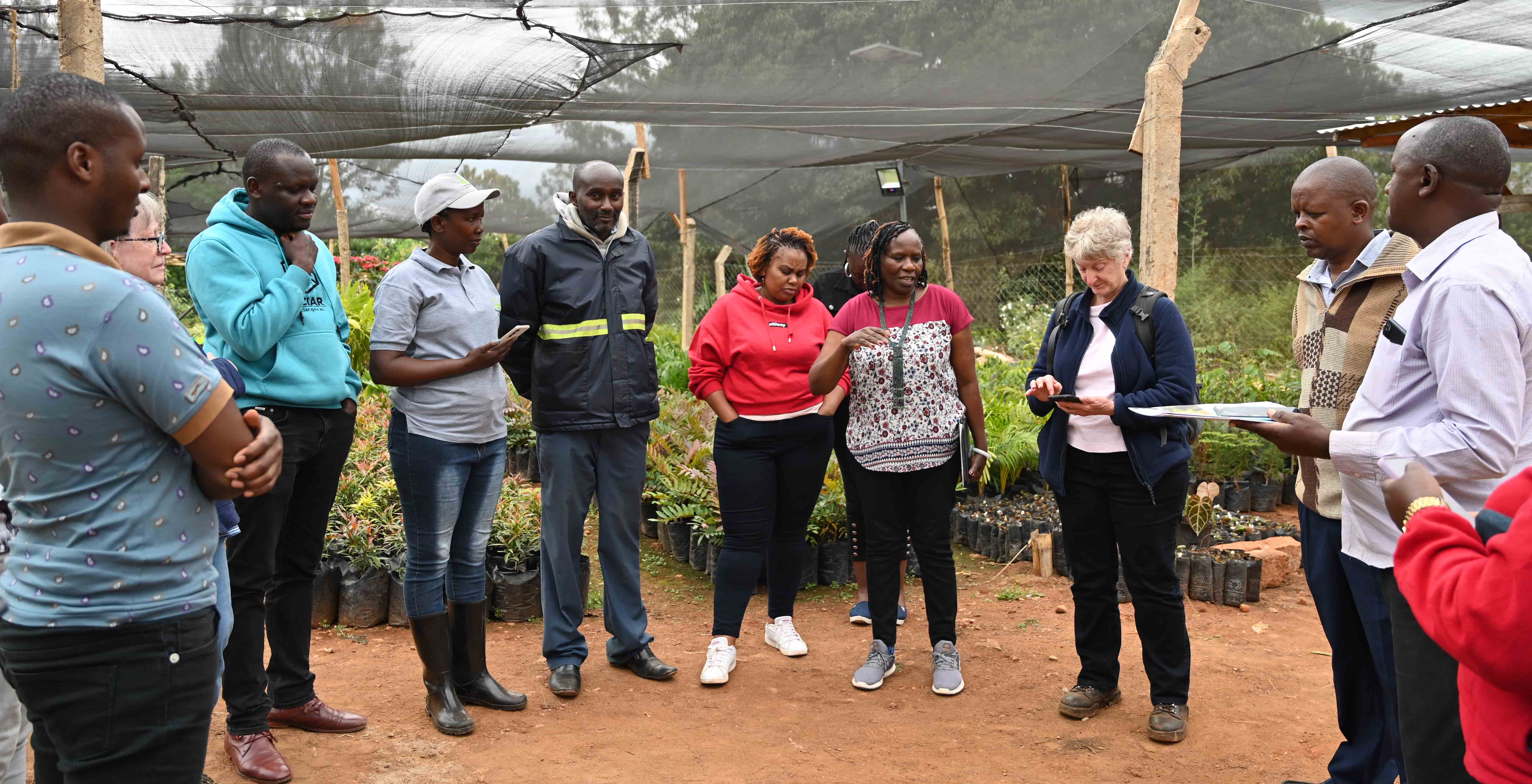 ACIAR staff, external reviewers, and farmers from Makueni county in Kenya listen intently as Prof Catherine Muthuri, ACIAR Project Leader and the Director and Regional Convener for East Africa at CIFOR-ICRAF, explains the App features.