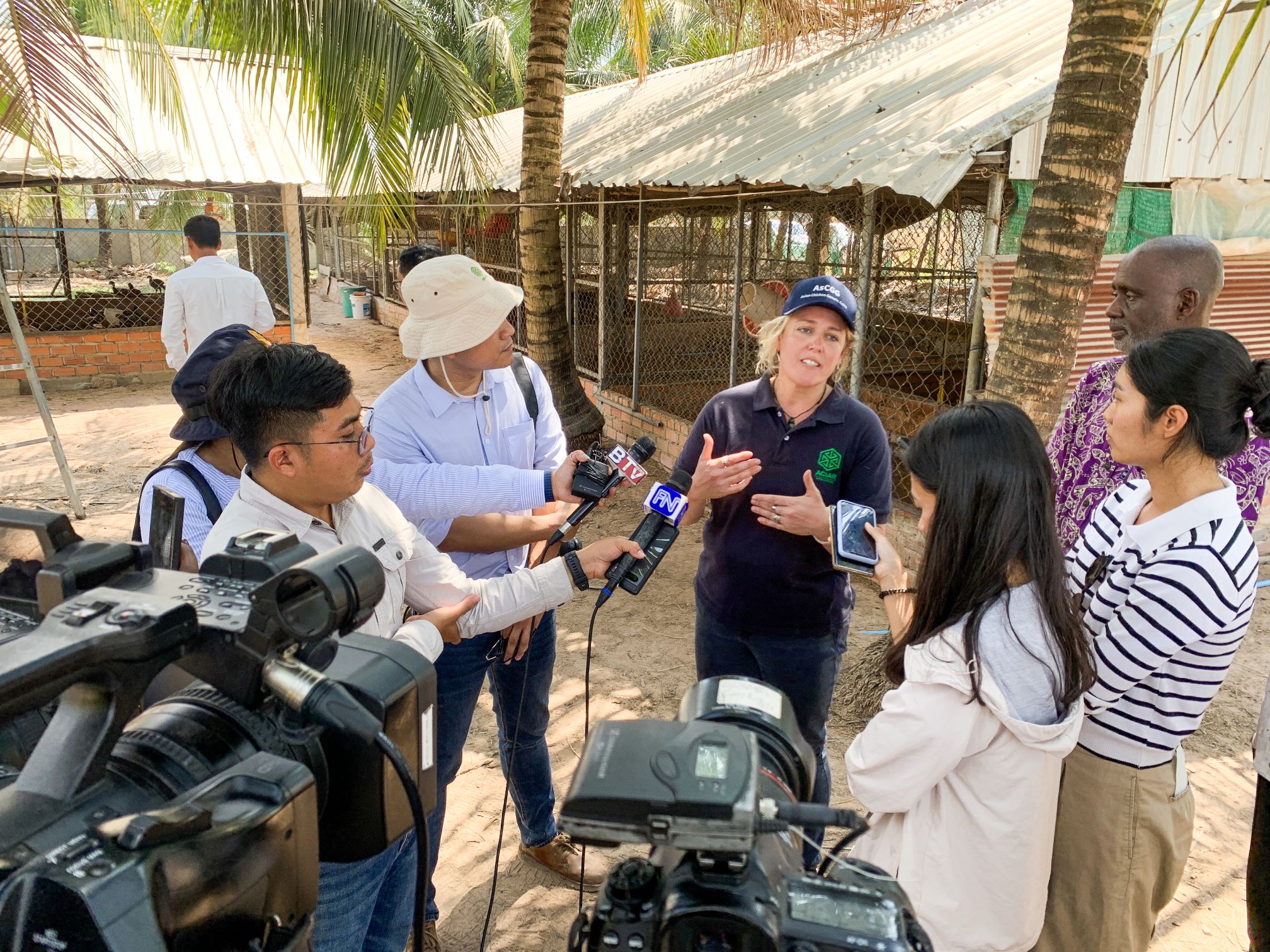 Woman being interviewed speaking with a team of journalists and reporters