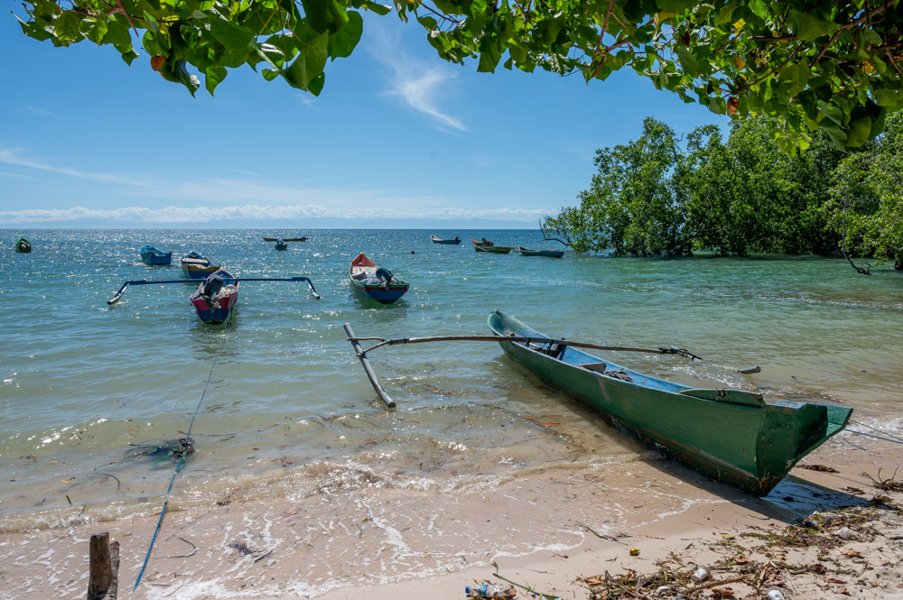 Fishing boats in a clear way bay on a sunny day with blue skies