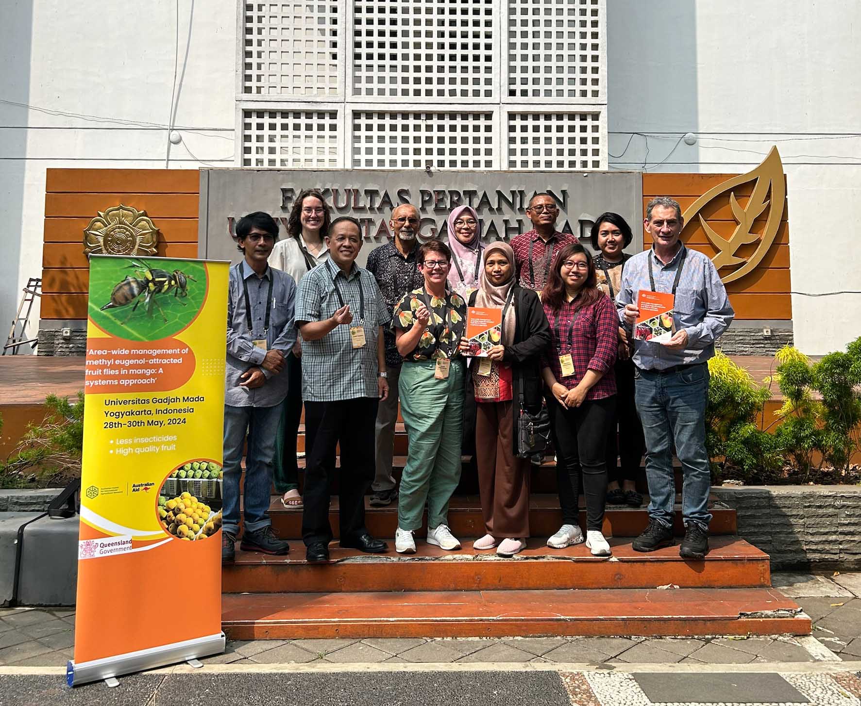 Authors celebrate the launch of their training manual and field guide, Area-wide management of methyl eugenol-attracted fruit flies in mango: A systems approach, at a recent workshop in Indonesia. Photo: ACIAR