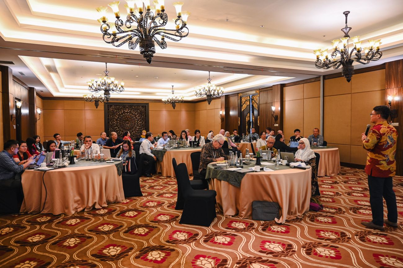 People sitting at round tables in an event room