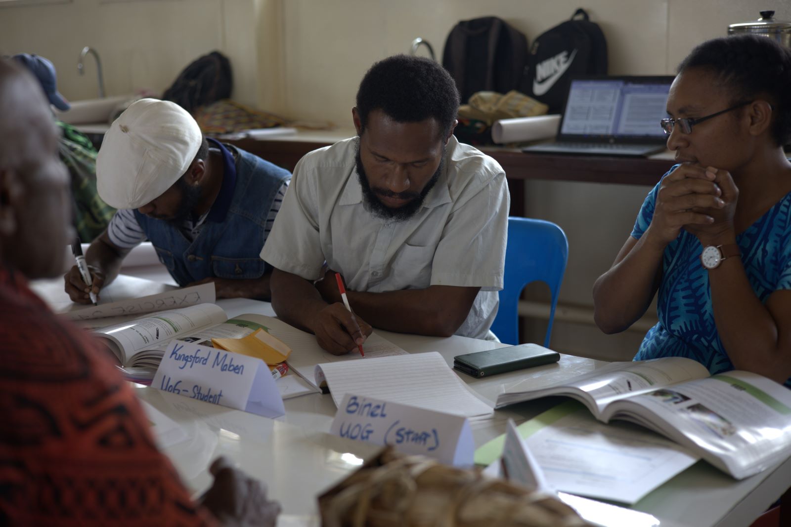 Students writing at a desk