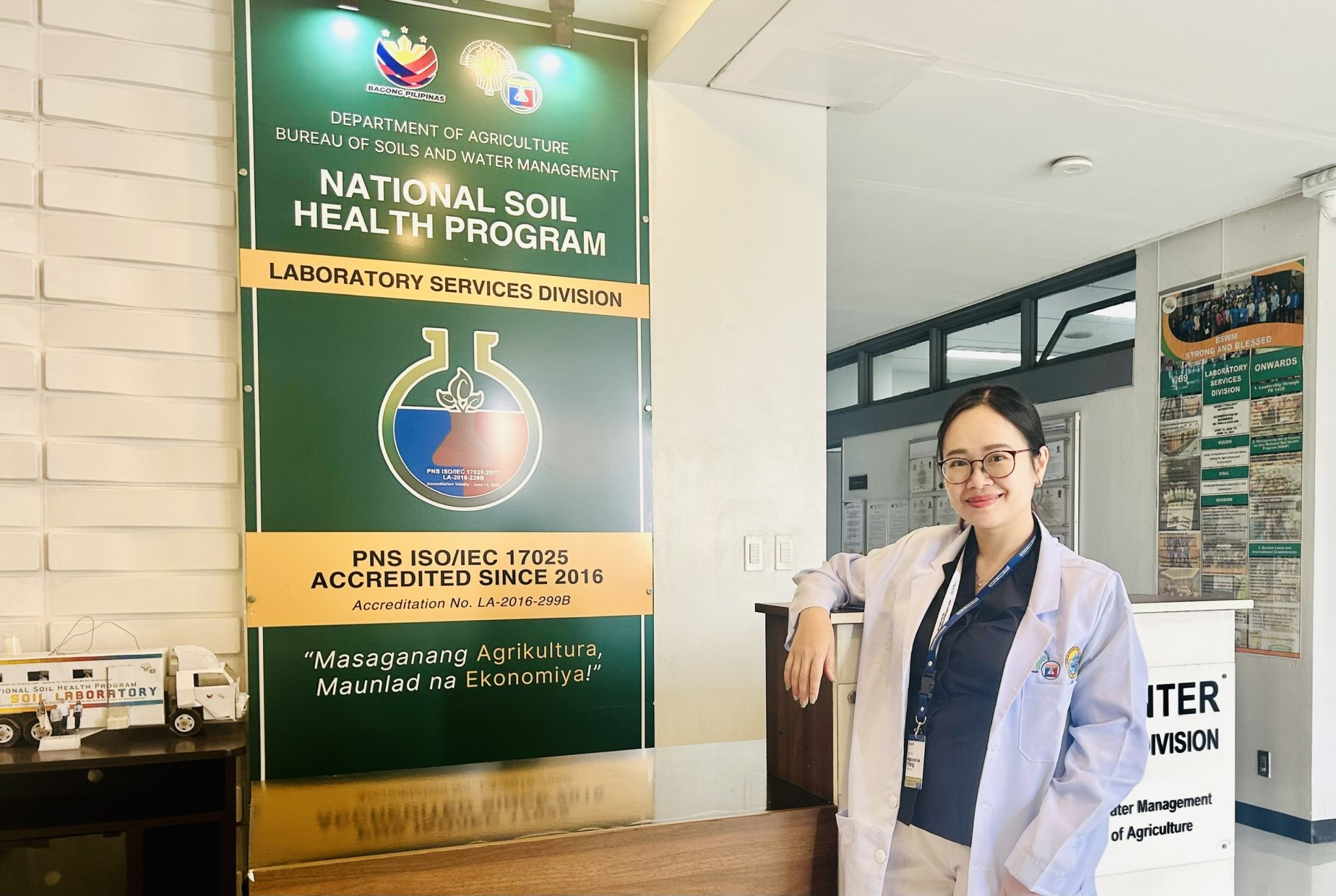 Women standing in front of a National Soil Health program banner