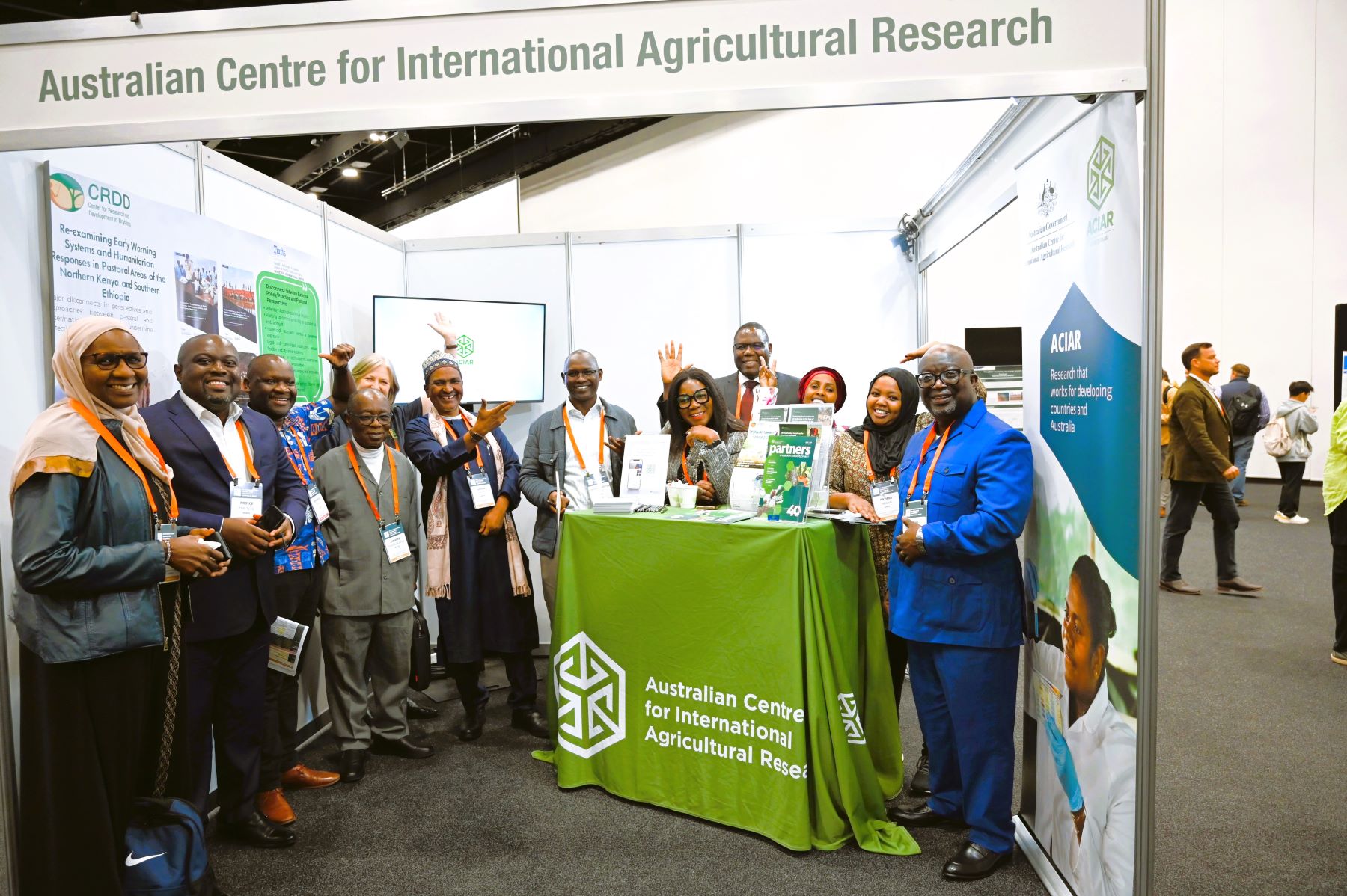 A group of people standing together at an exhibition booth