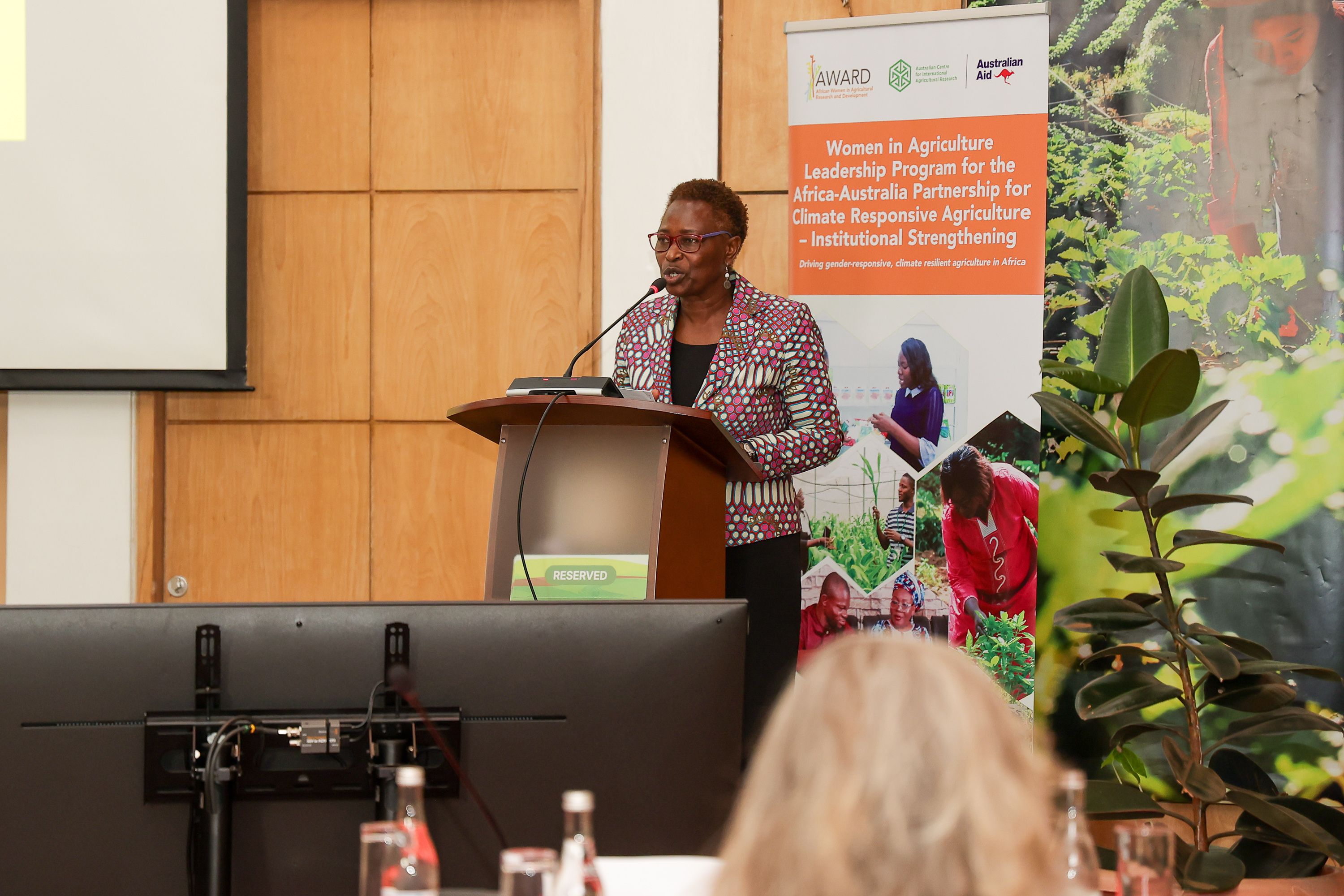 Speaker presenting at a podium during the launch of a women in agriculture leadership program