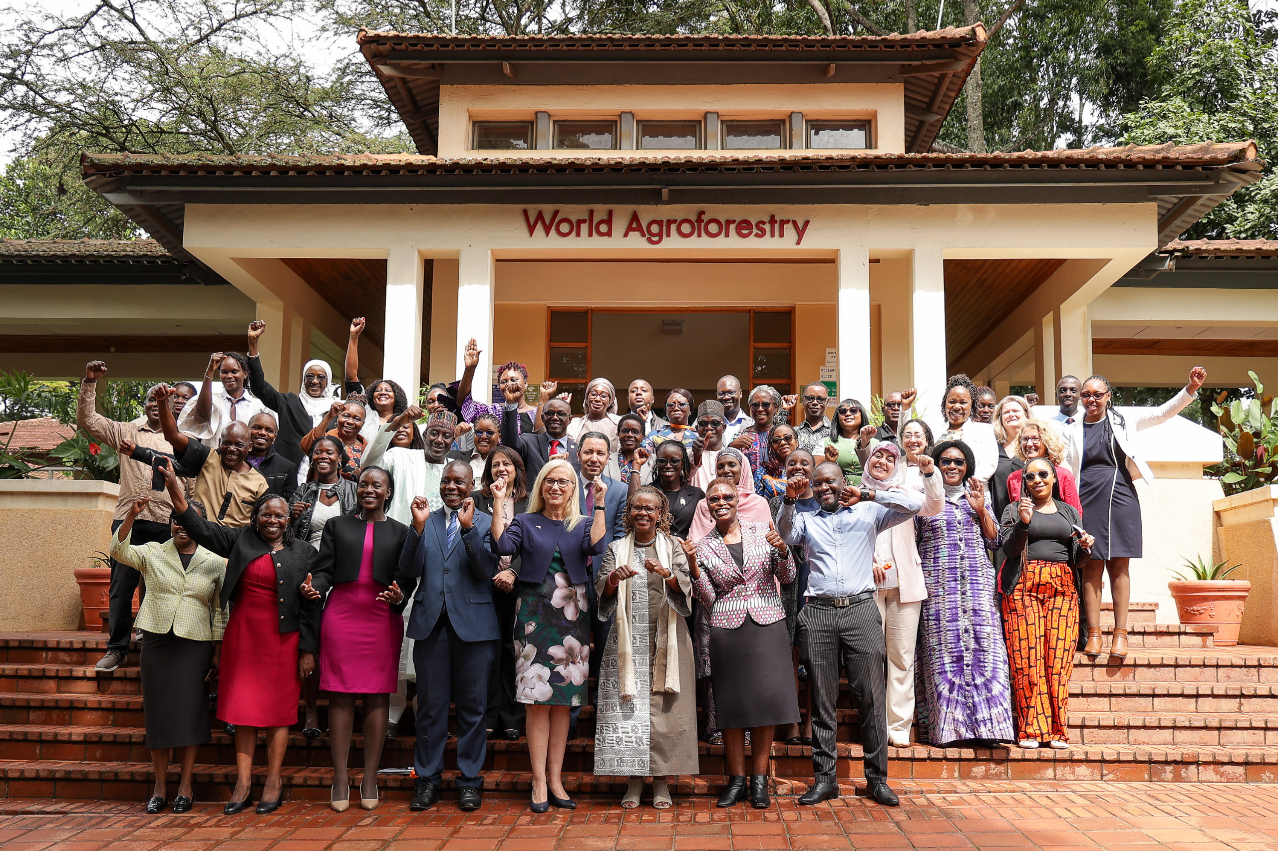 Group of participants celebrating outside the World Agroforestry building