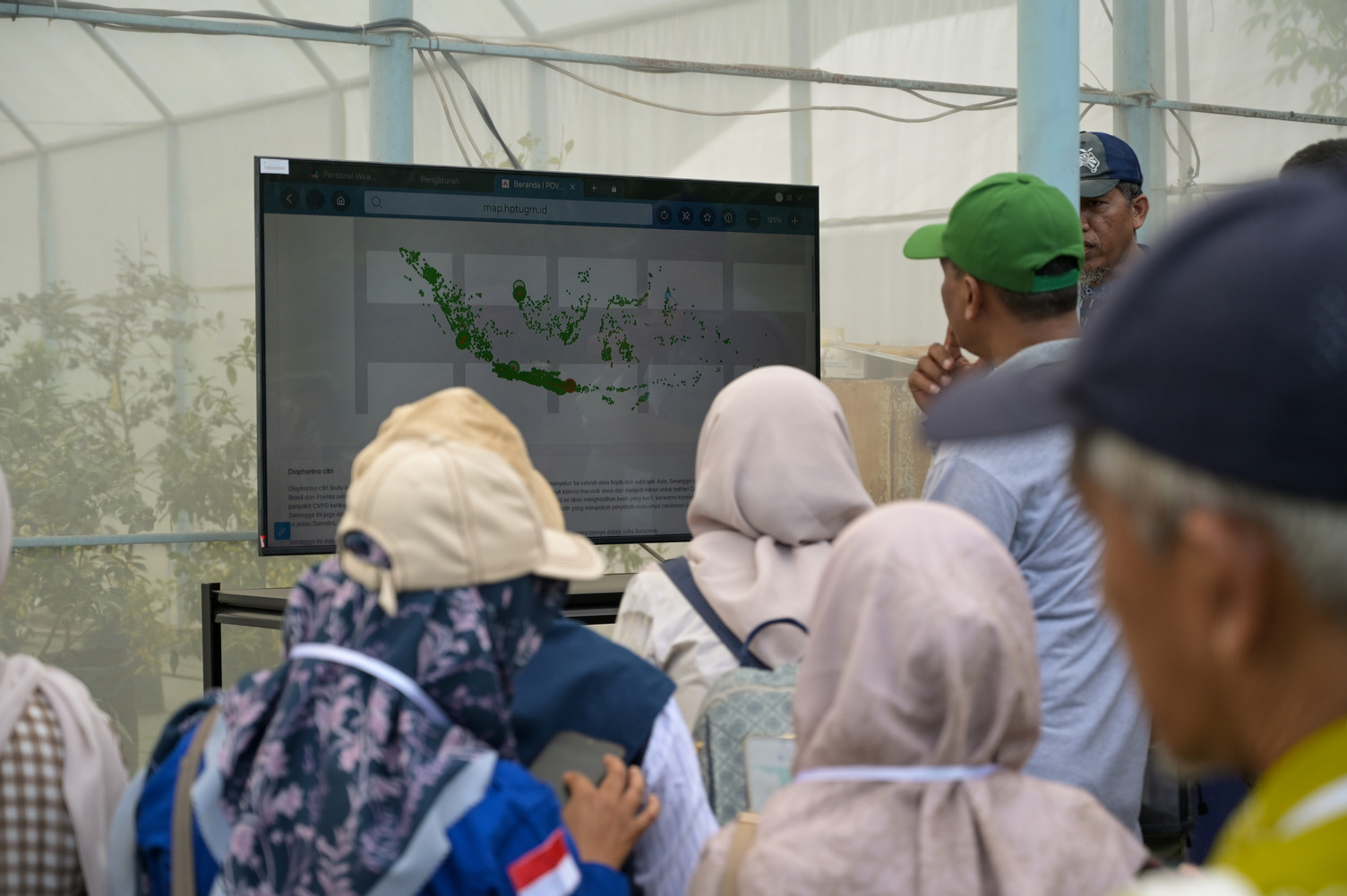 Participants viewing a digital map display during a project briefing.