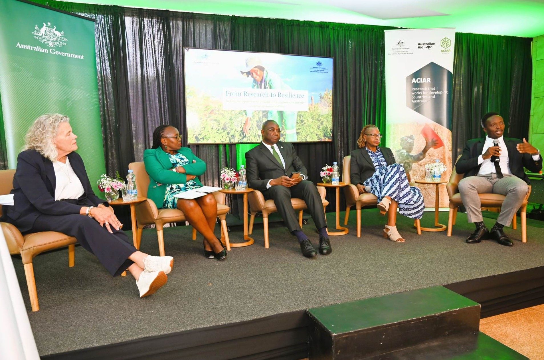 Panel discussion with five speakers on stage