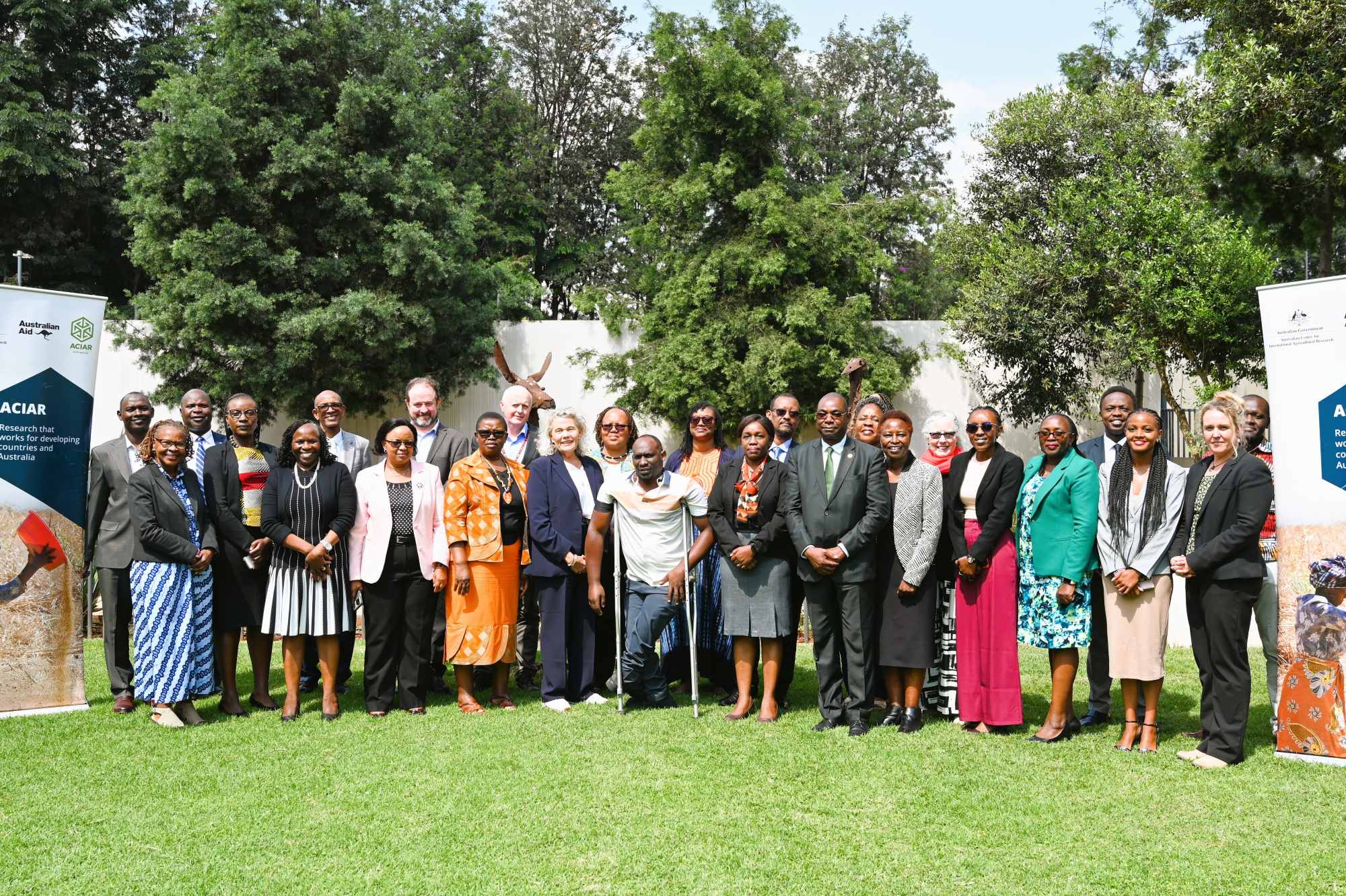 Group photo of event participants standing on a lawn