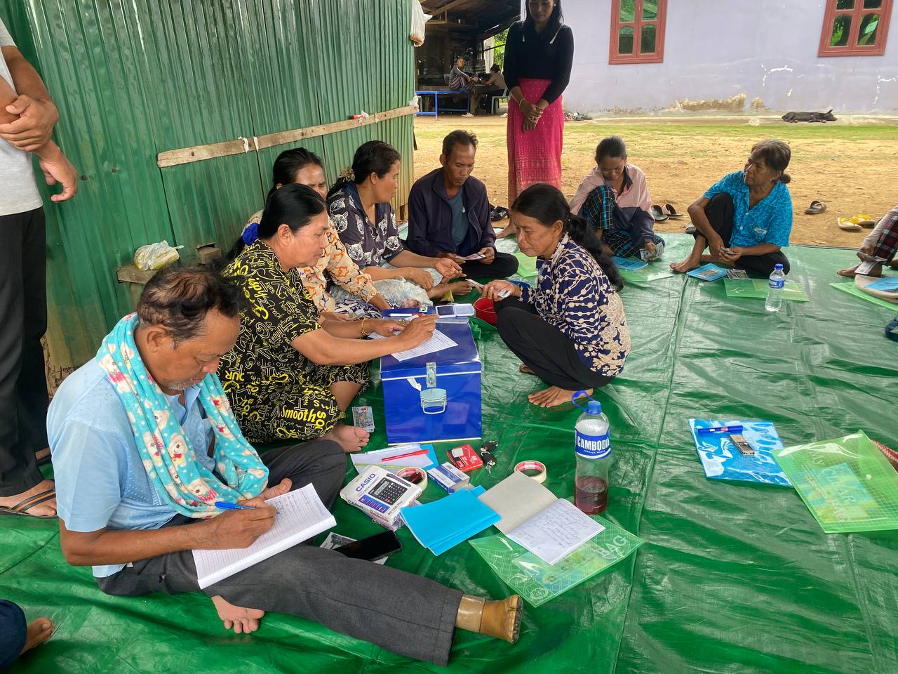 Community members participate in a village savings group meeting.