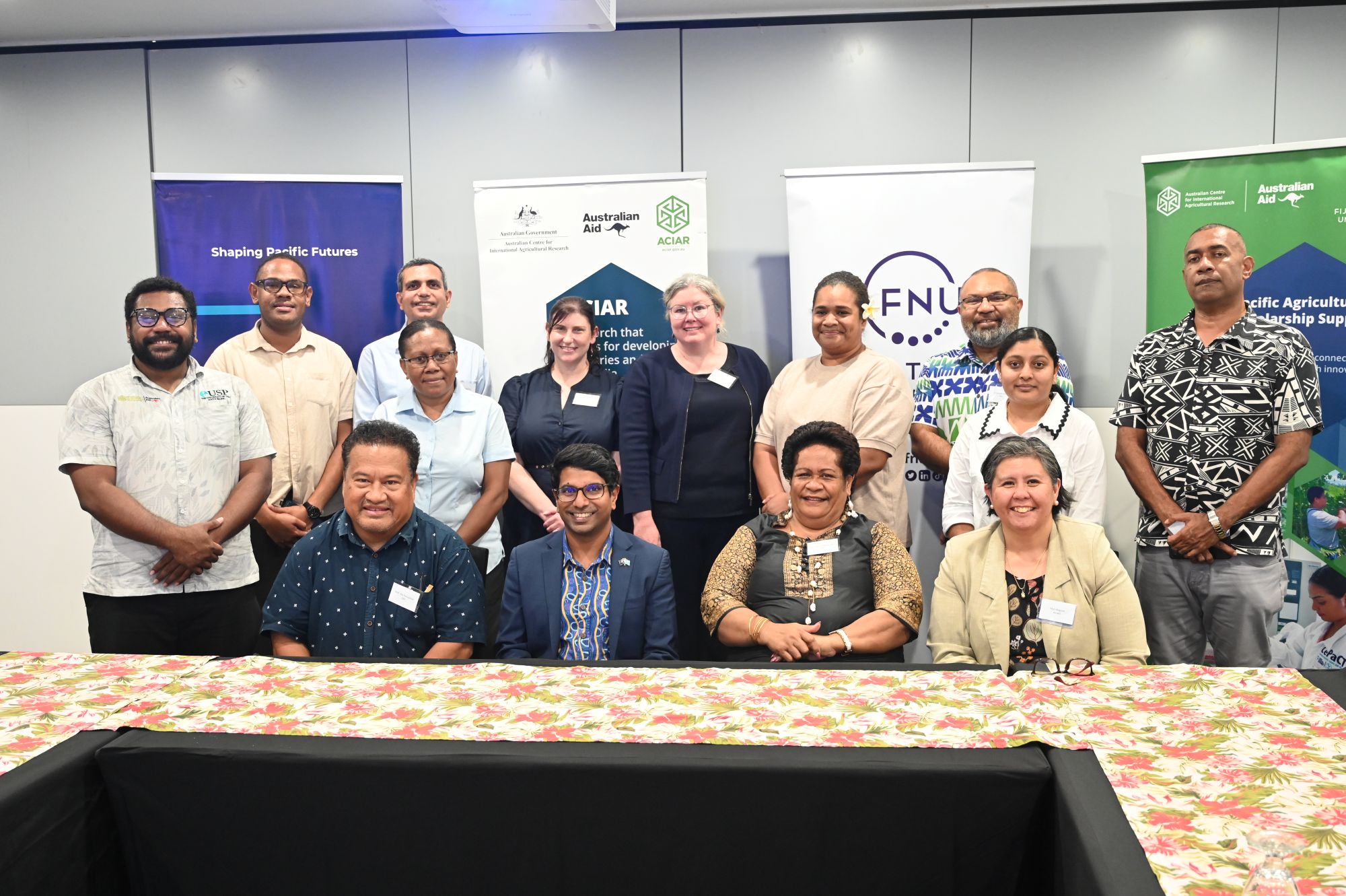 Participants and partners gathered for a group photo at a Pacific agricultural scholarship program event.