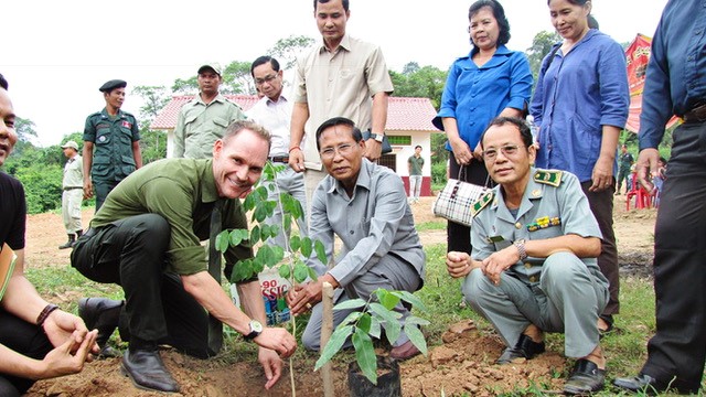 The book's author, Stephan Bognar (left), planting trees with the local authorities and villagers on denuded hilltops in Cambodia.