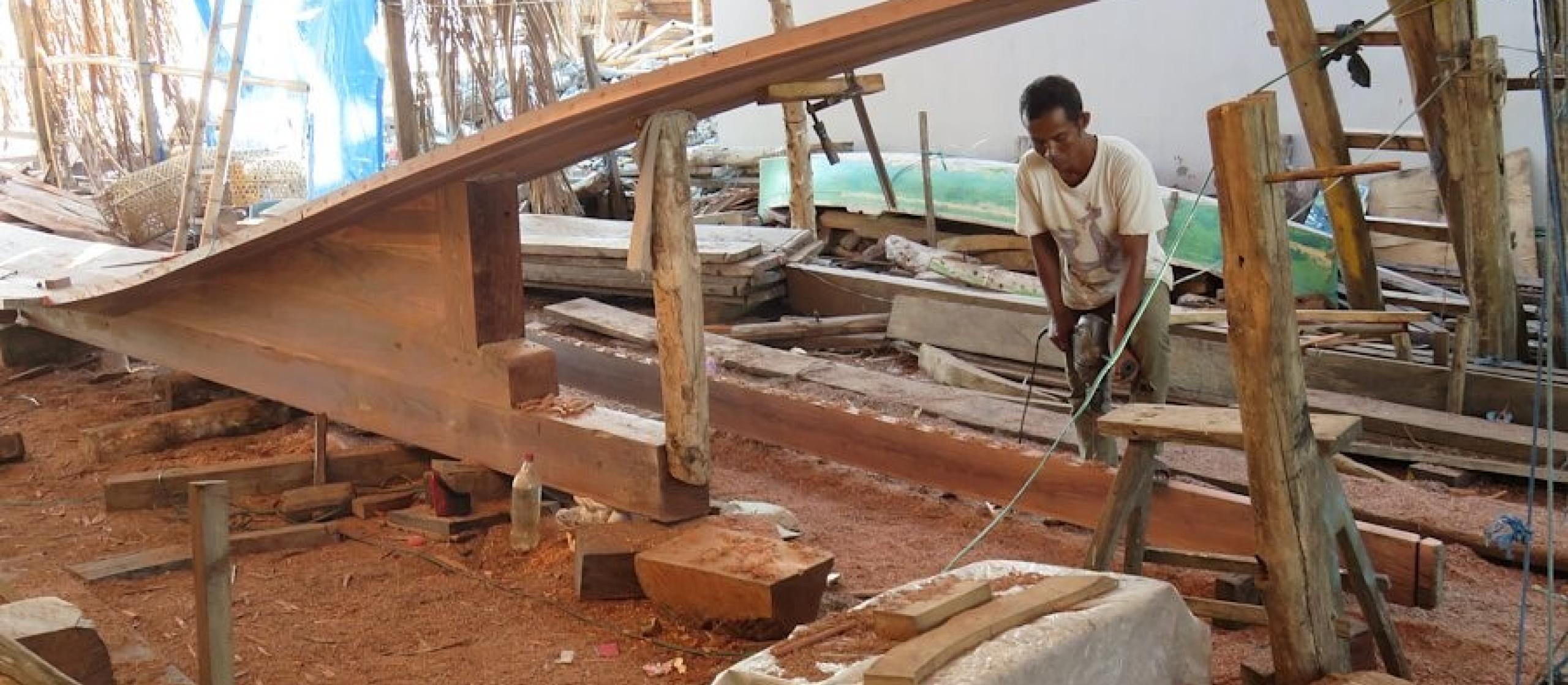 A man works in a wood workshop