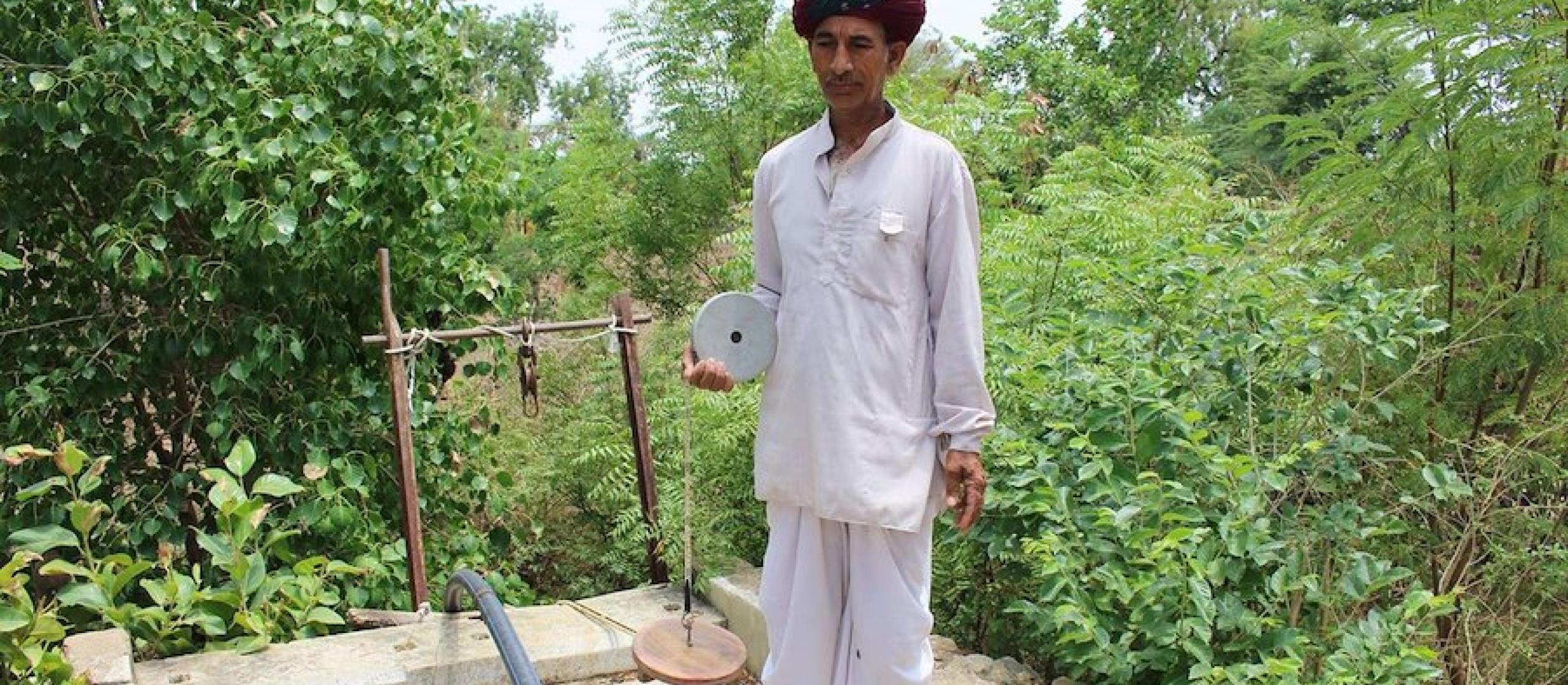 One of the Bhujal Jankaars measuring groundwater levels manually. Credit: B. Mesashwari