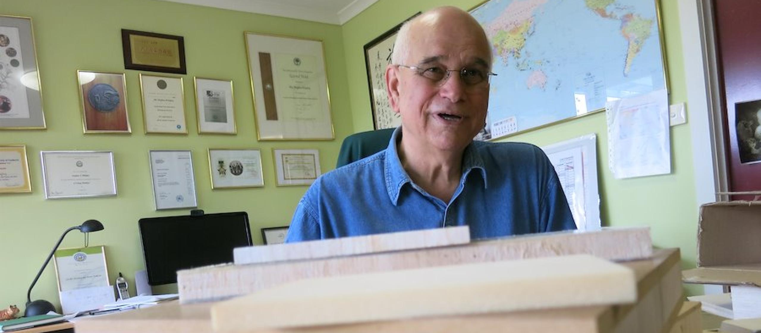 Stephen Midgley sits behind balsa wood