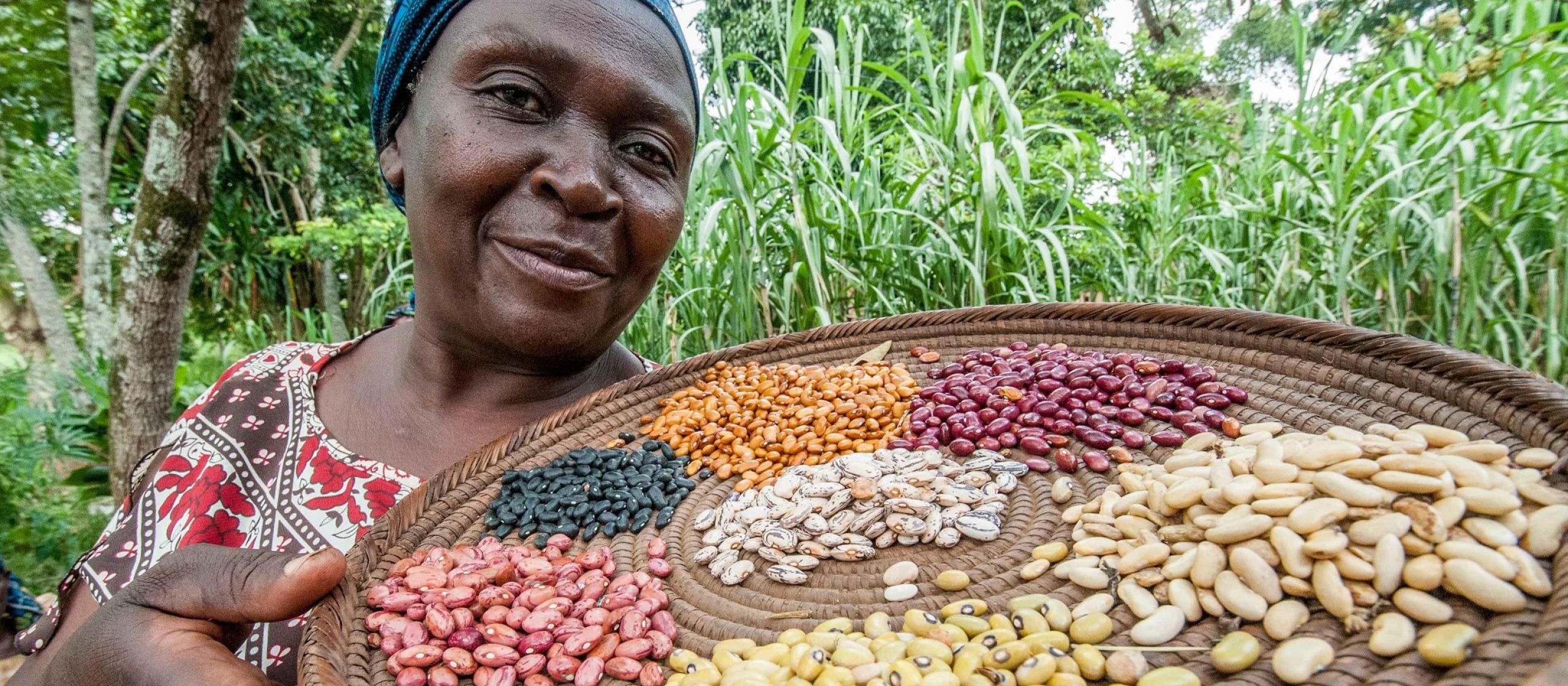 woman holding tray of assorted beans