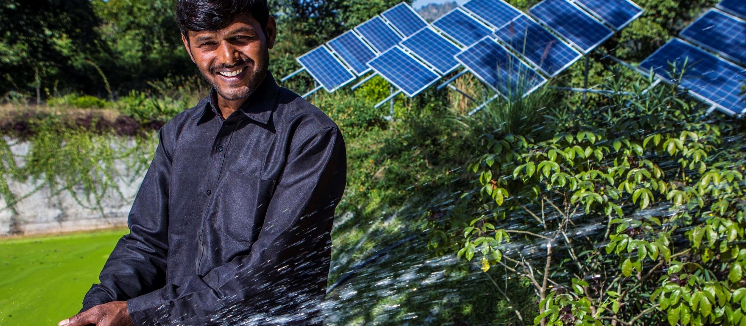 man in front of solar panels