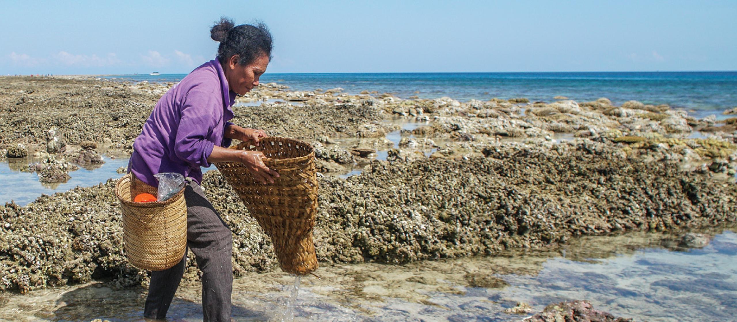 Woman fishing walking through ocean pools