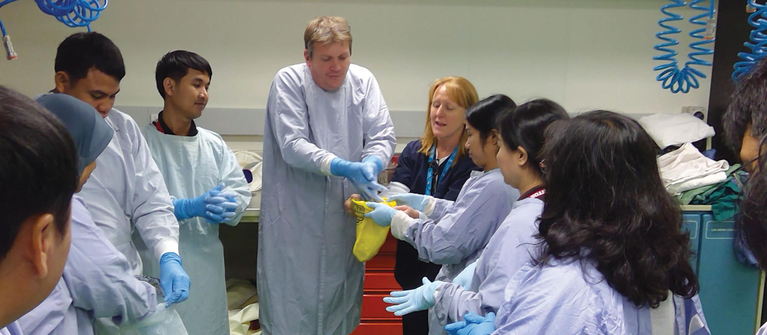 people putting on gloves to prevent spreading diseases