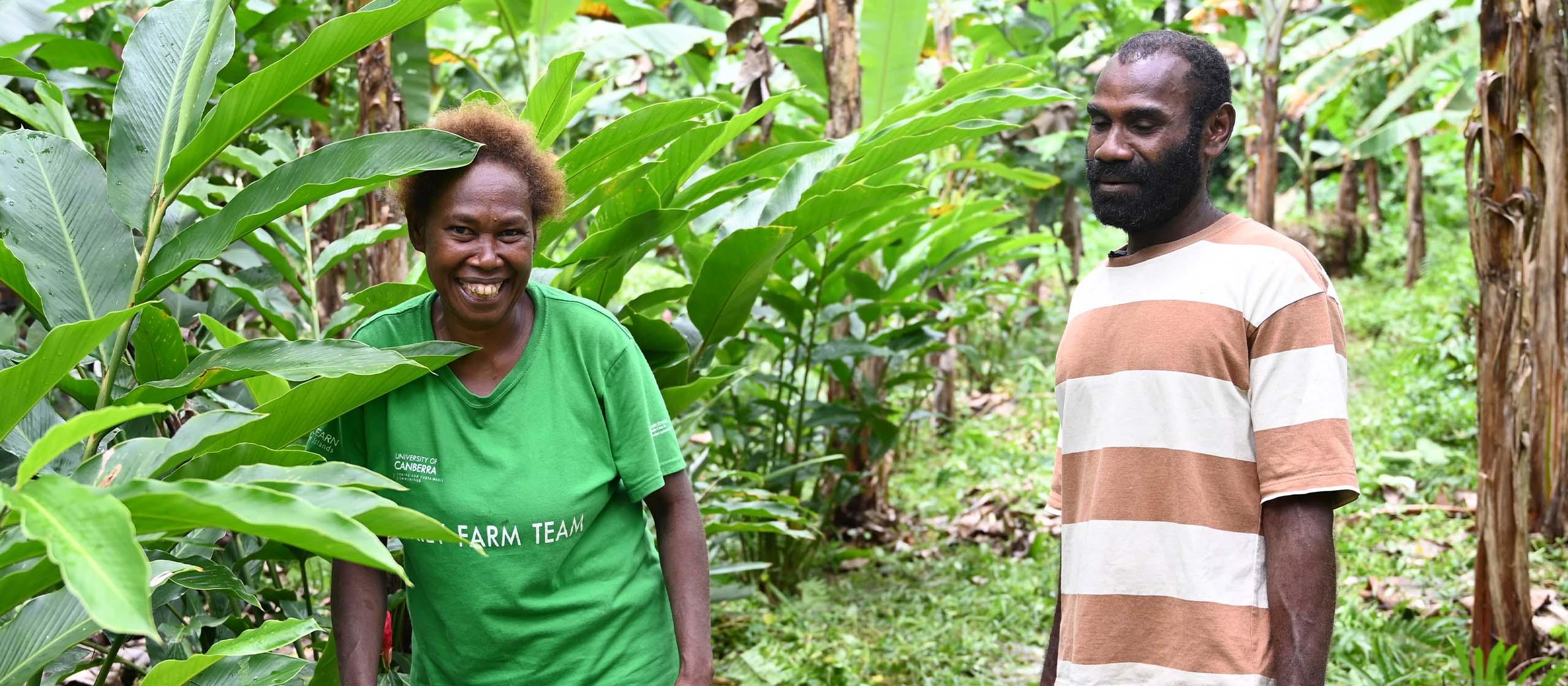 Two people standing in a forest smiling