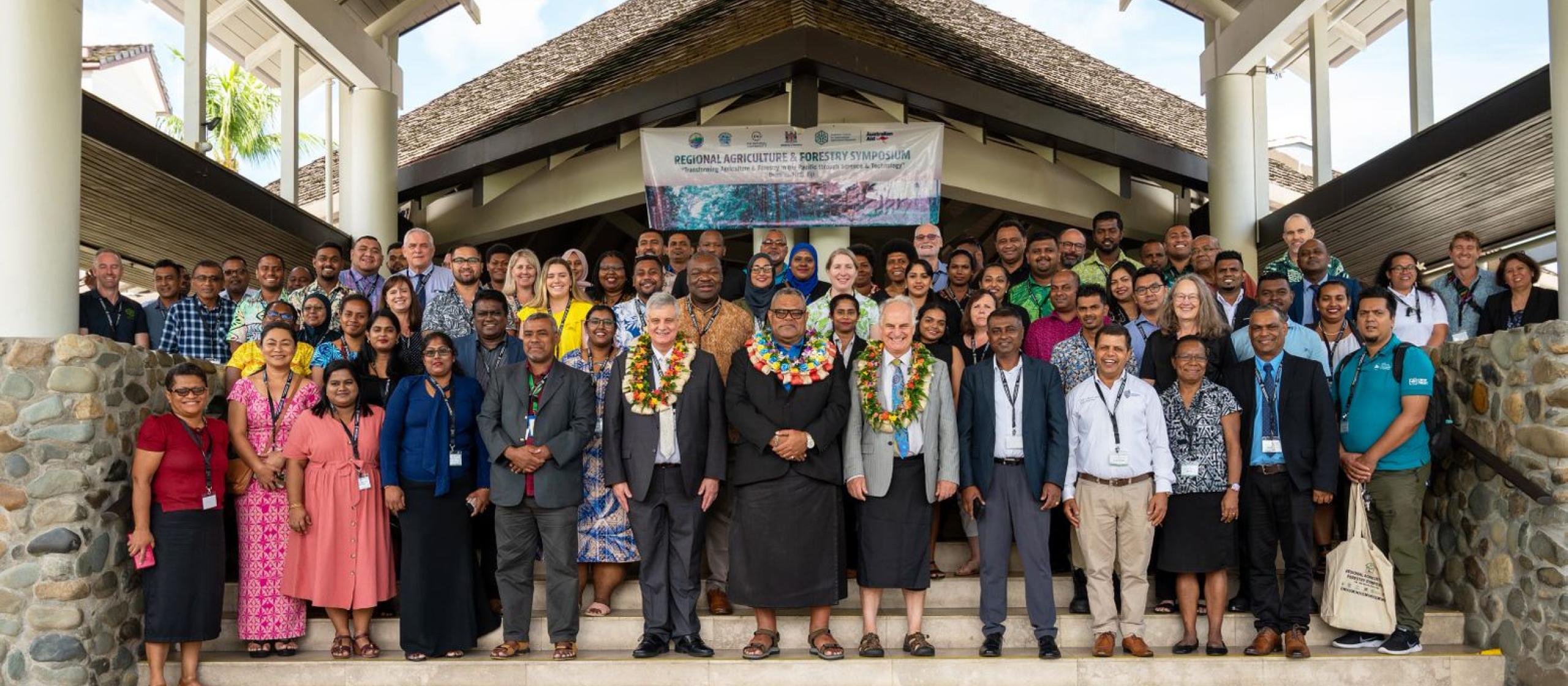 Participants at the start of the Regional Agriculture and Forestry Symposium 2023, standing for group photo.